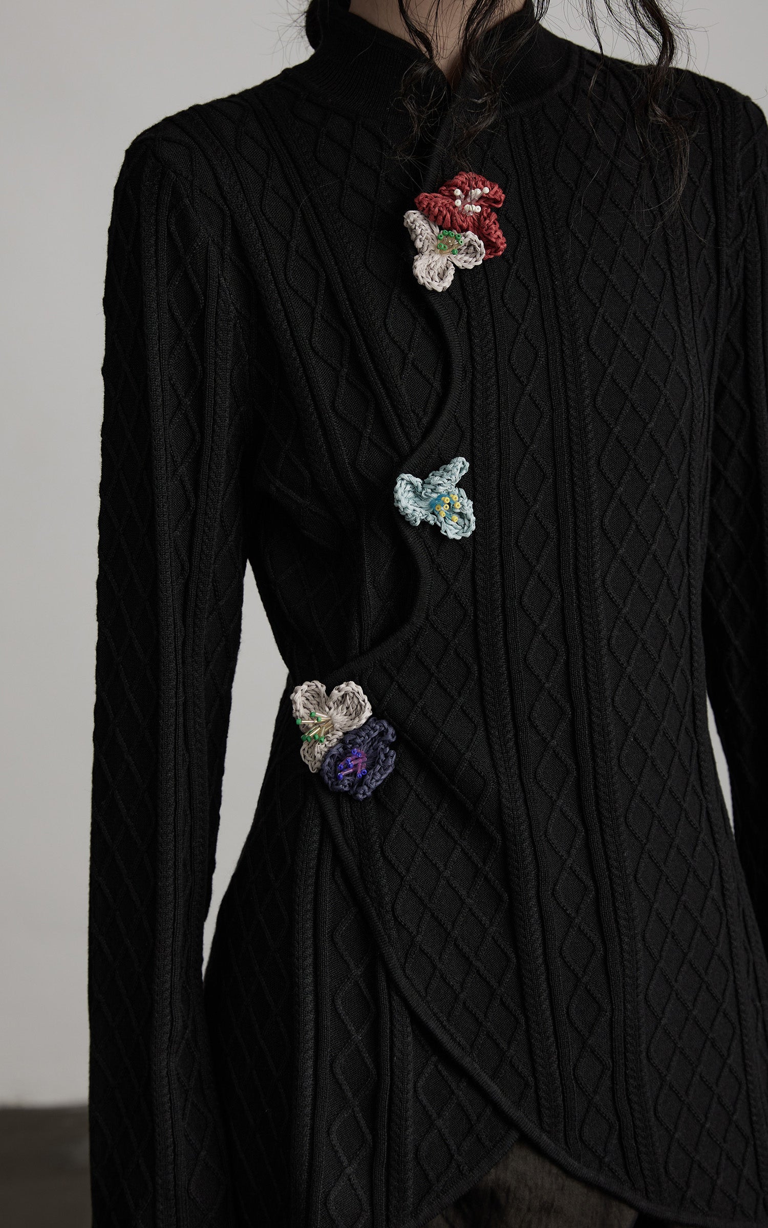 INDULGE Diamond Knit Asymmetric Top with Crochet Floral Details