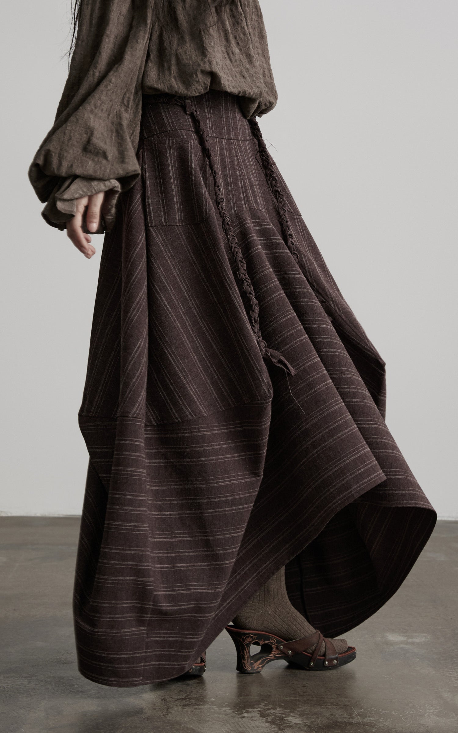 DOINDULGE Shadow Stripe Asymmetric Draped Skirt with Raw Braided Details