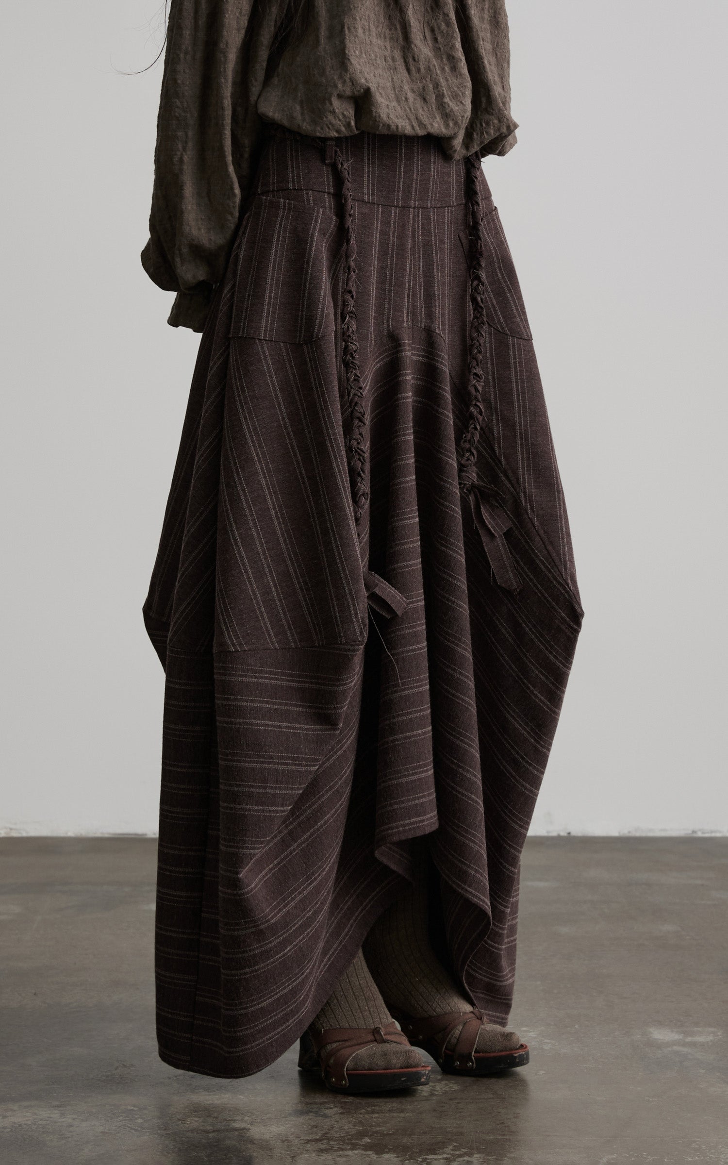DOINDULGE Shadow Stripe Asymmetric Draped Skirt with Raw Braided Details