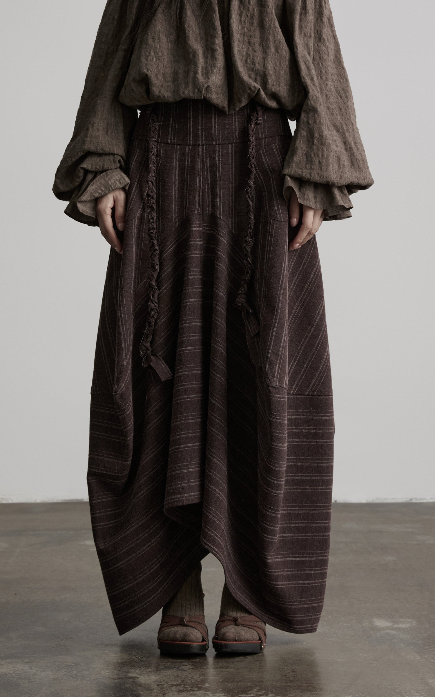 DOINDULGE Shadow Stripe Asymmetric Draped Skirt with Raw Braided Details