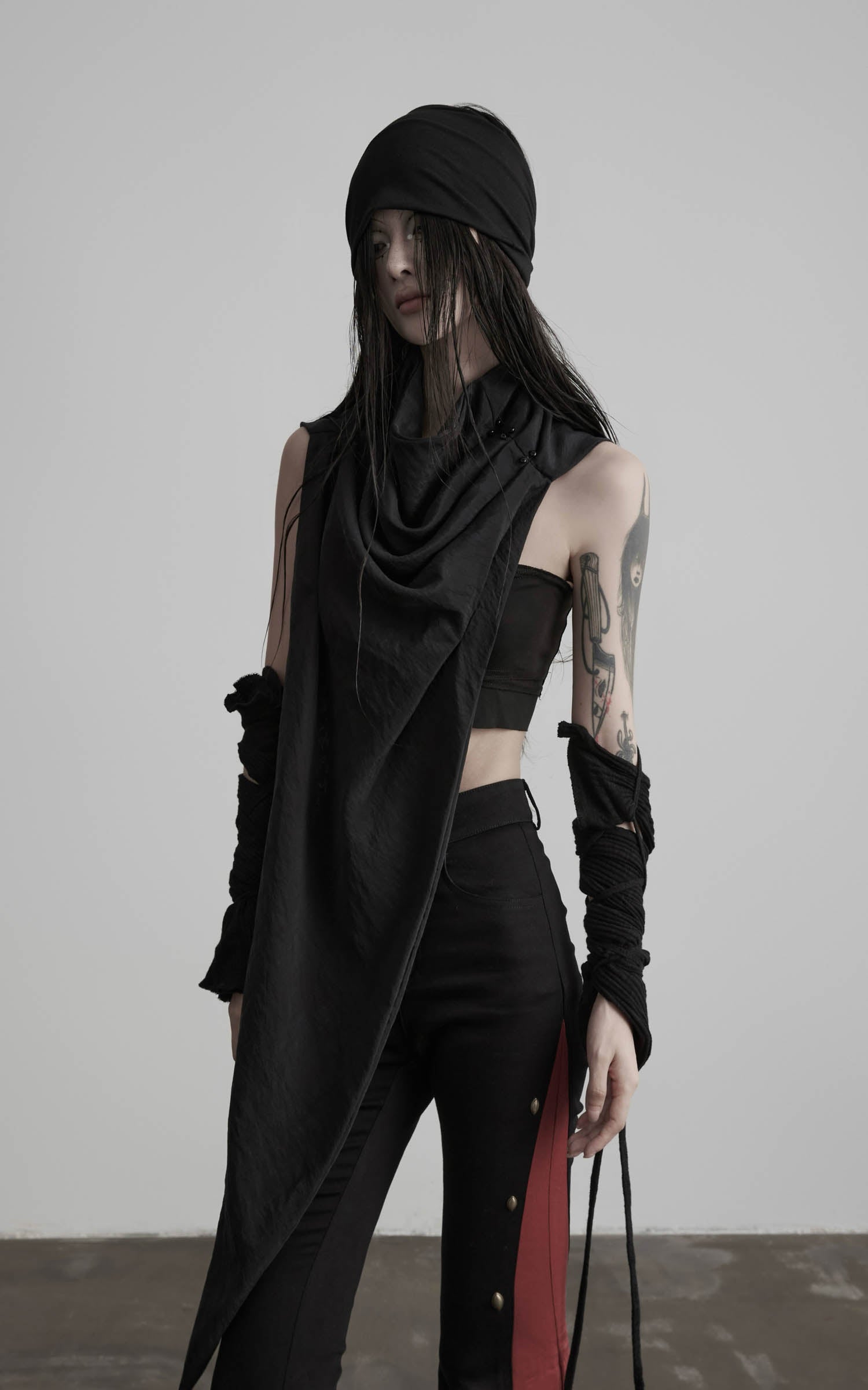 Angled view of black asymmetric drape scarf shawl with sharp pointed hem