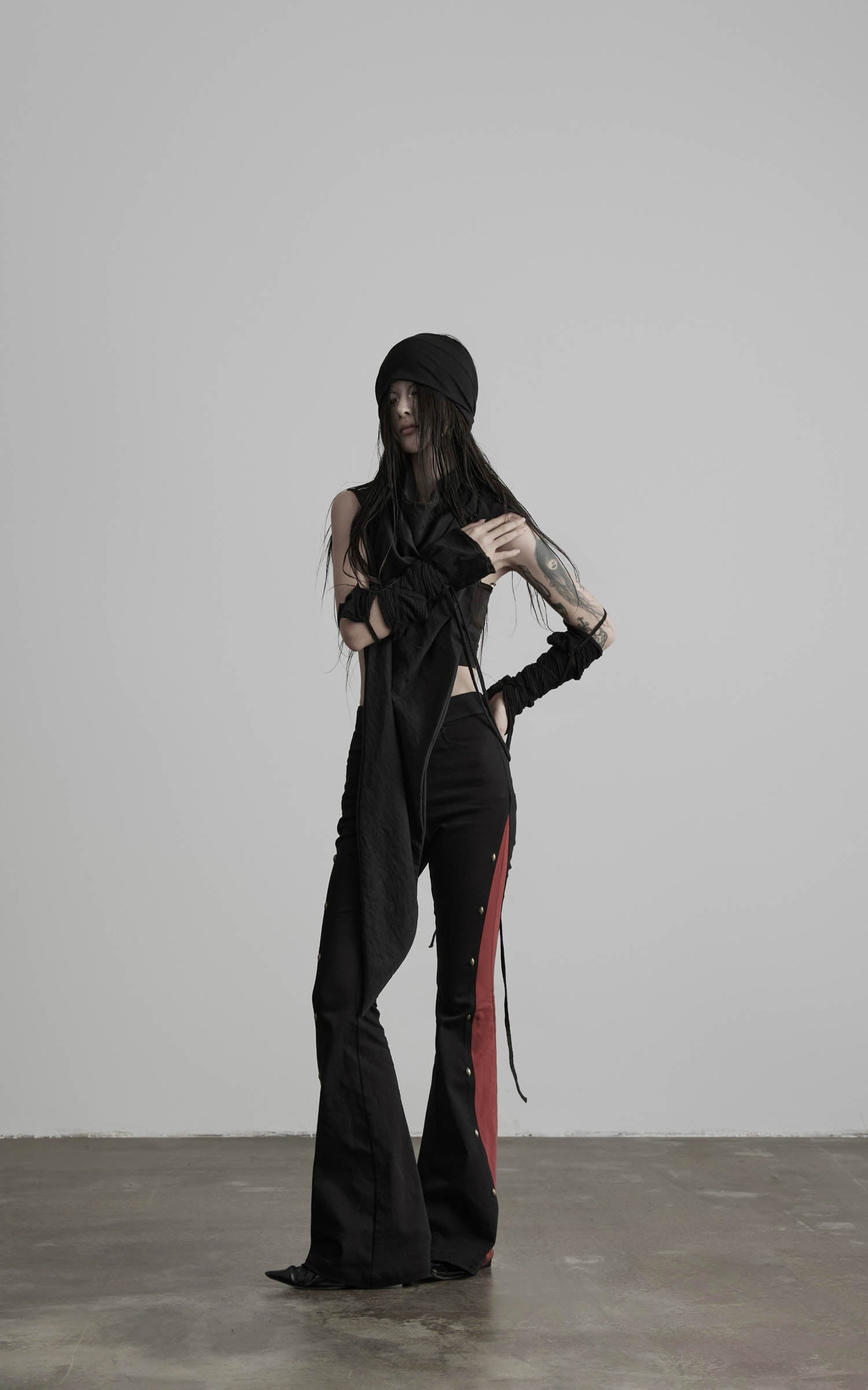 Front view of black asymmetric drape scarf shawl with elongated layered construction