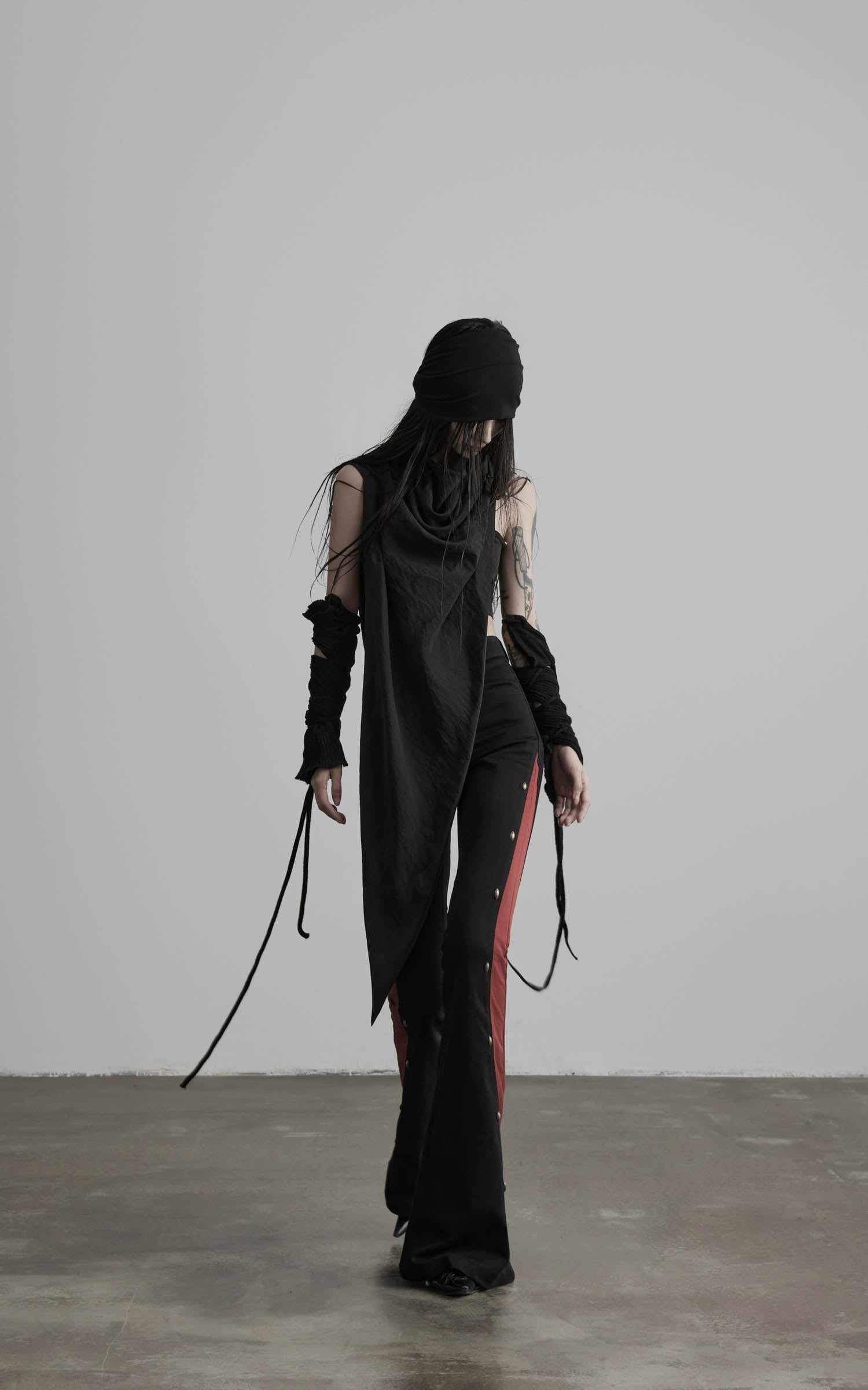 Angled view of black asymmetric drape scarf shawl with flowing layered drape