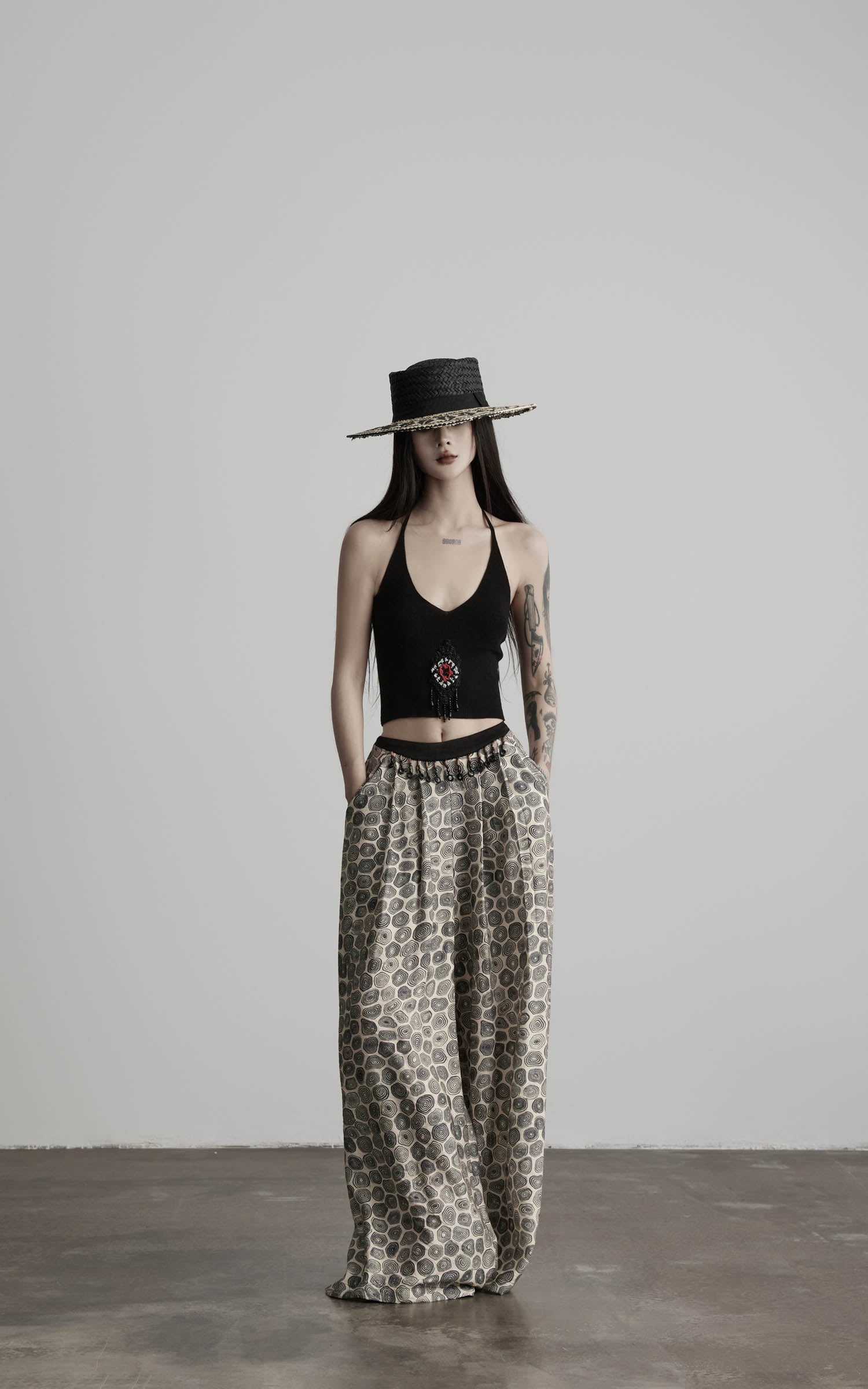 front view of black beaded halter knit top with relaxed full body styling