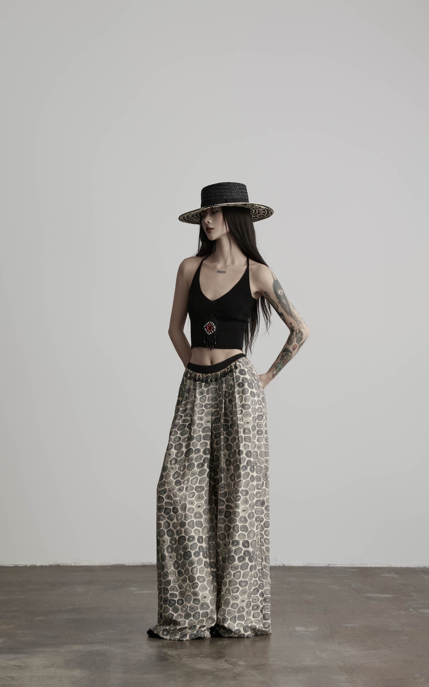 side view of black beaded halter knit top with clean neckline shape