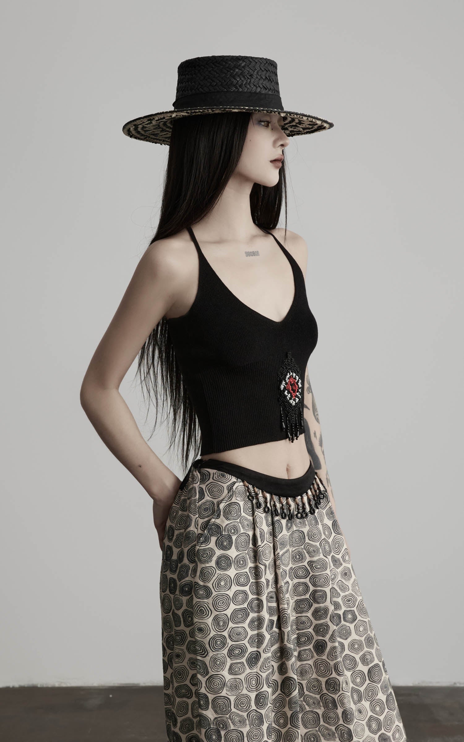side view of black beaded halter knit top with ribbed texture