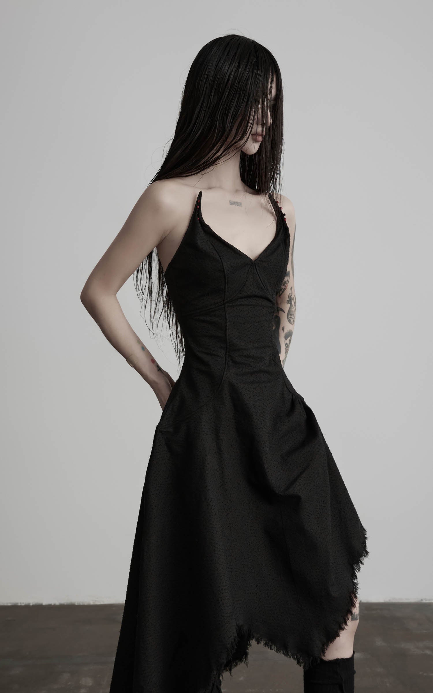 Black cotton bustier dress with curved waist seams angled view