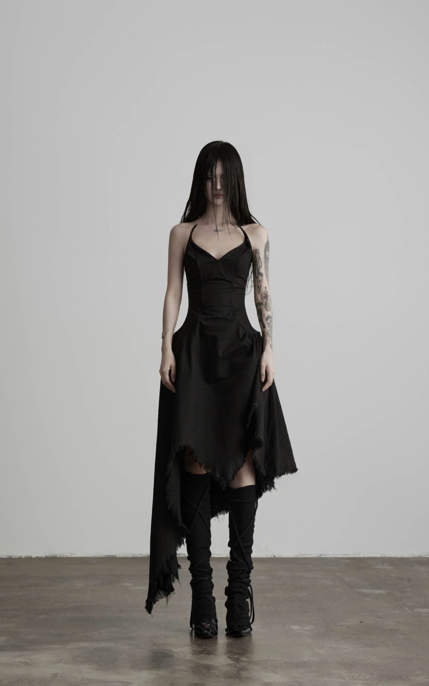Black cotton bustier dress with asymmetric raw hem front view