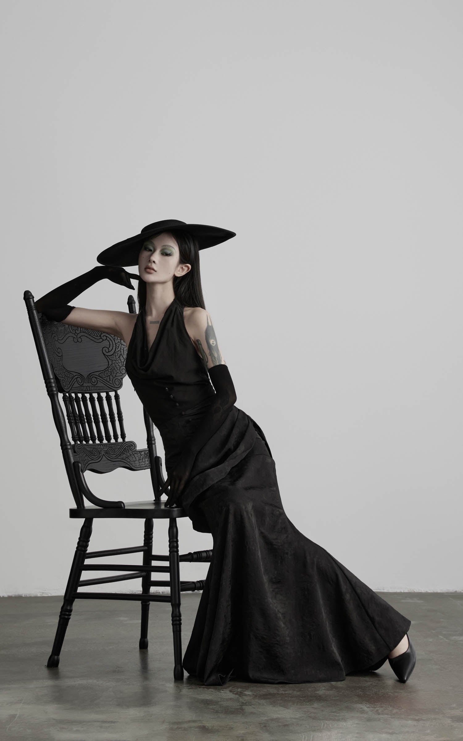 Black halter cowl neck maxi dress seated outfit view