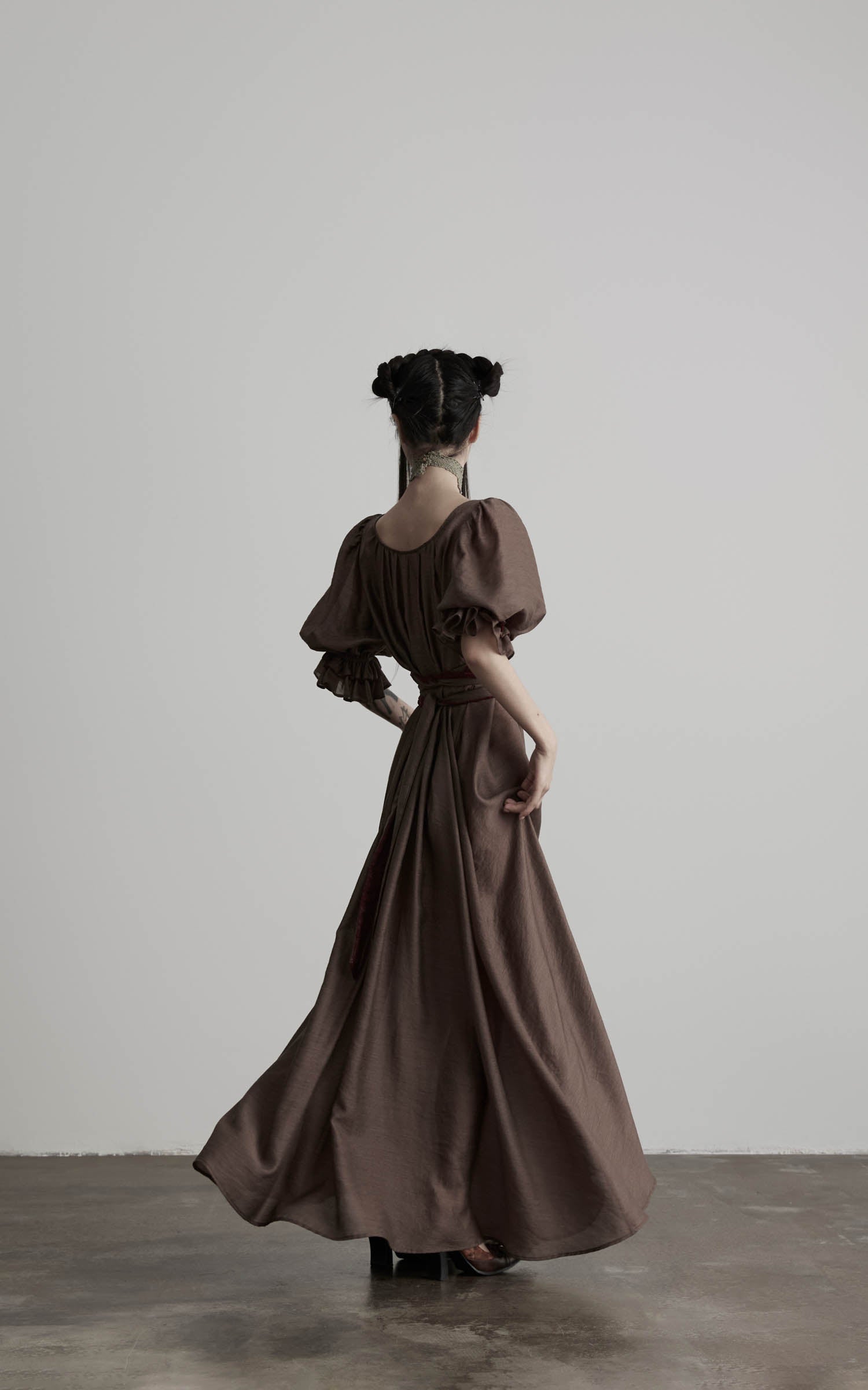 back view of brown maxi dress with flowing skirt in motion