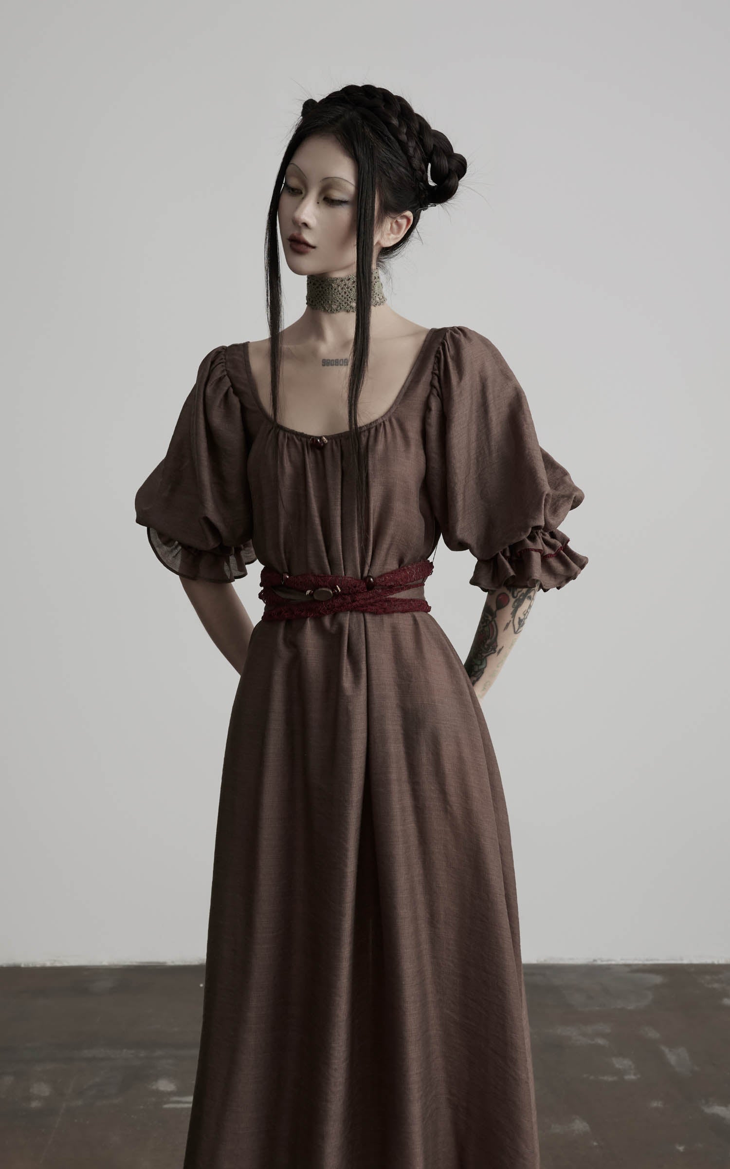 close-up of brown maxi dress with soft pleats and fitted bodice