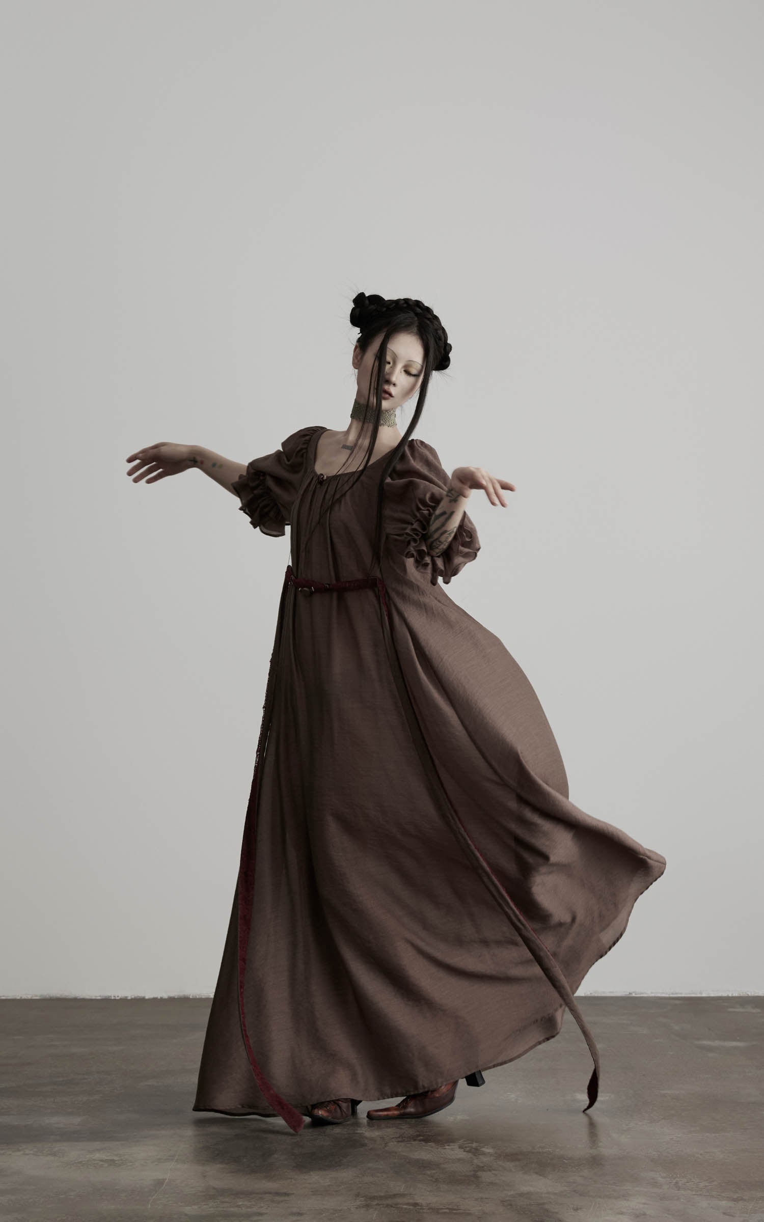 front view of brown maxi dress with flowing hem and soft drape