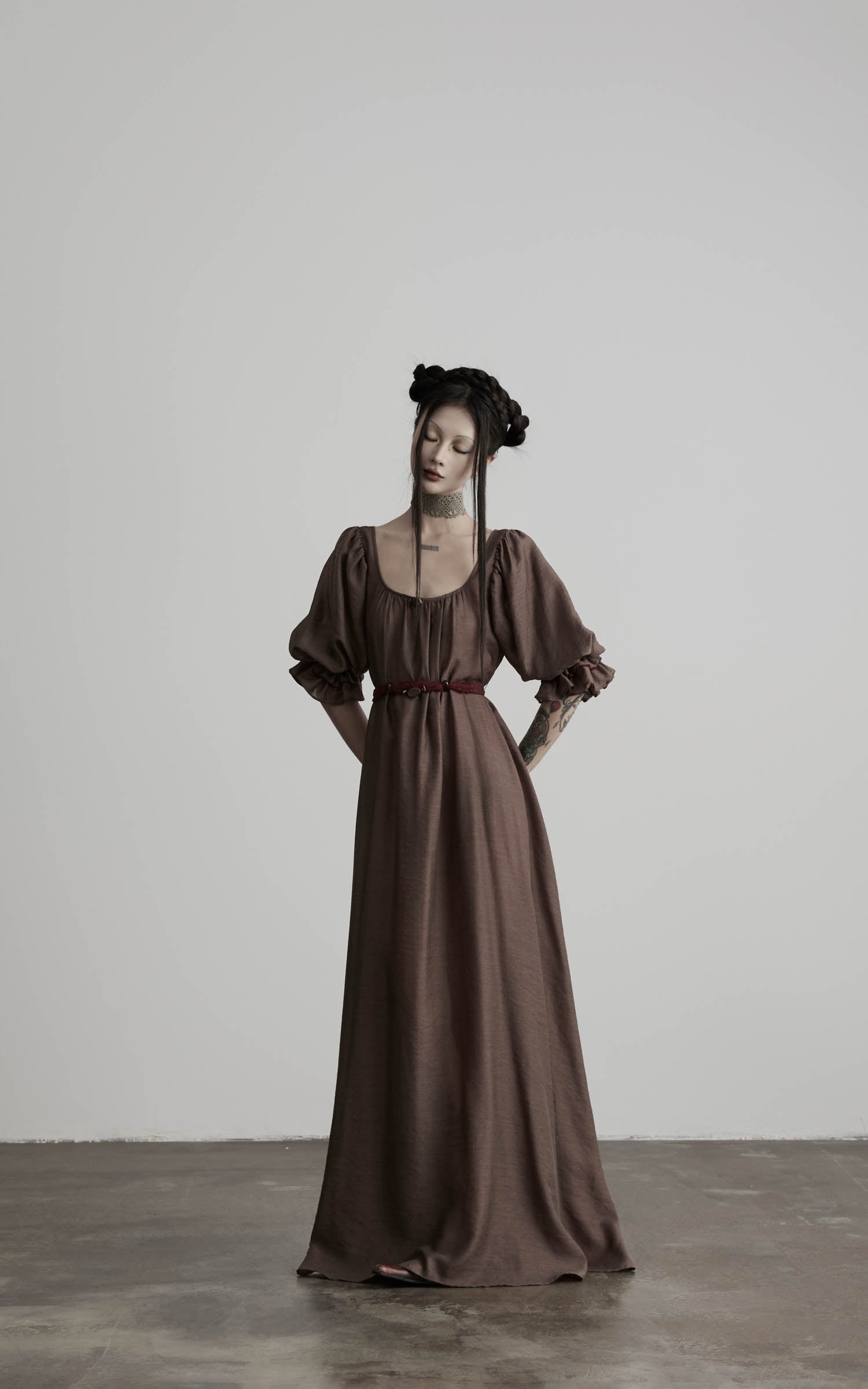front view of brown maxi dress with puff sleeves and cinched waist