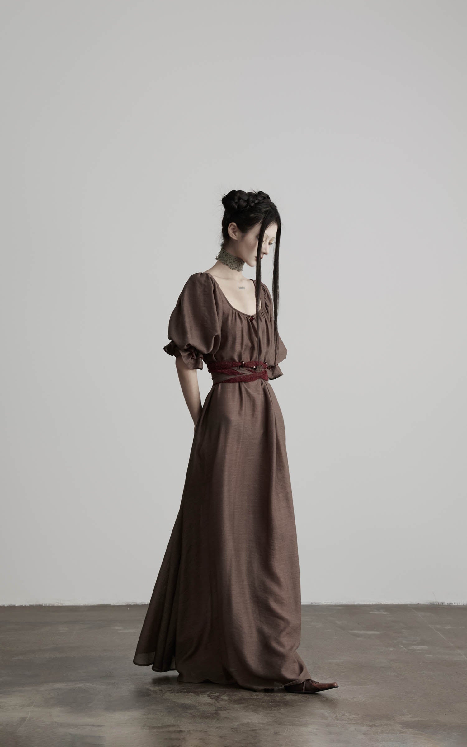 side view of brown maxi dress with long silhouette and drape