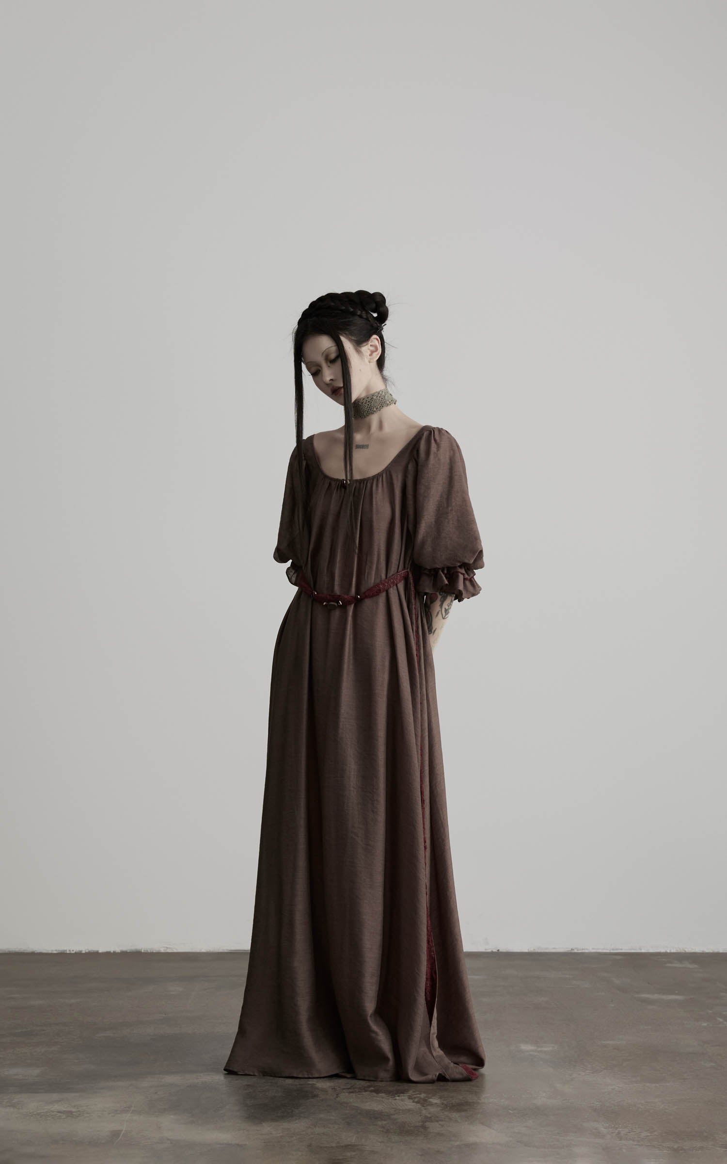 side view of brown maxi dress with long drape and soft structure