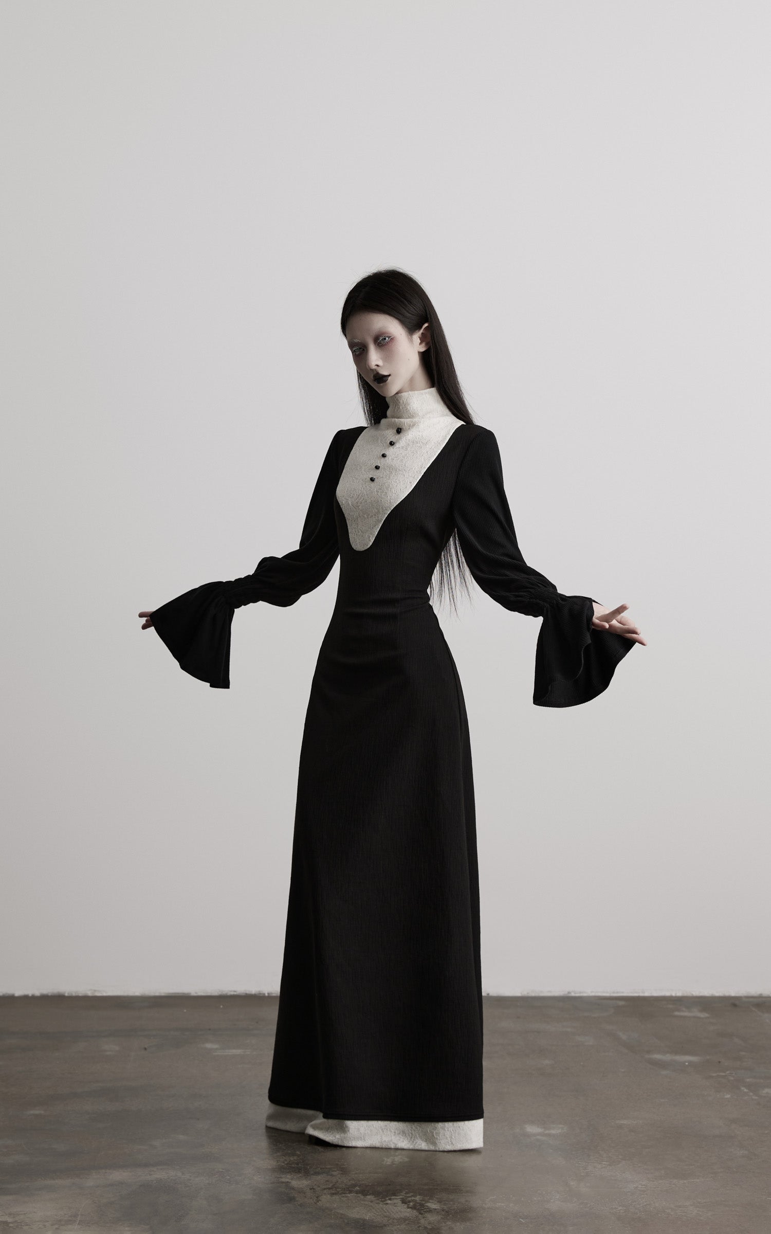 angled front view of black contrast panel high neck dress in motion