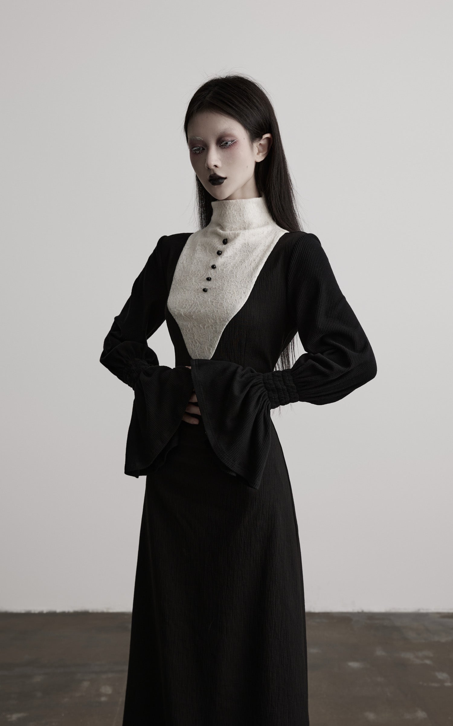 front view of black high neck dress with contrast panel upper detail