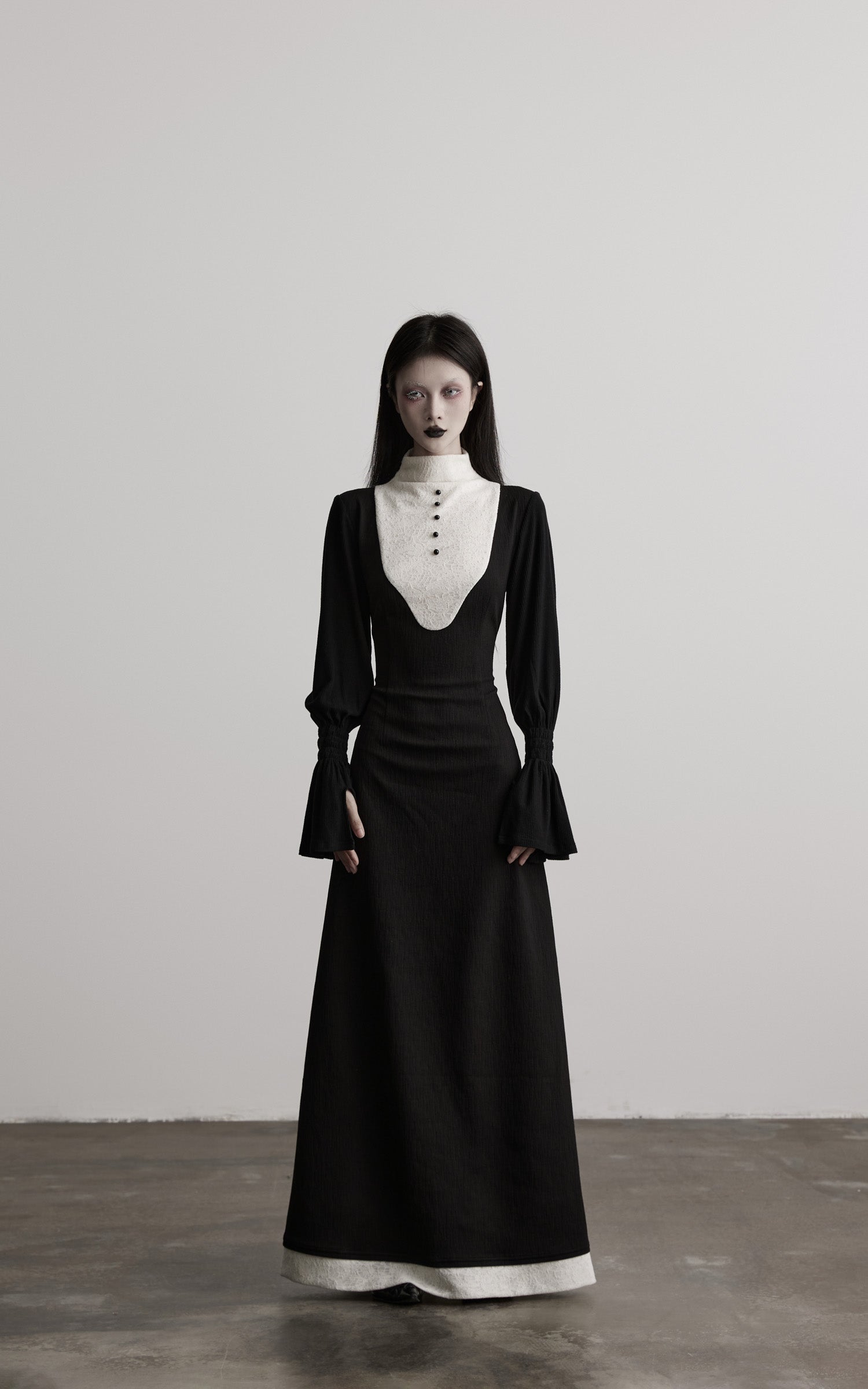 front view of black contrast panel high neck dress with long sleeves