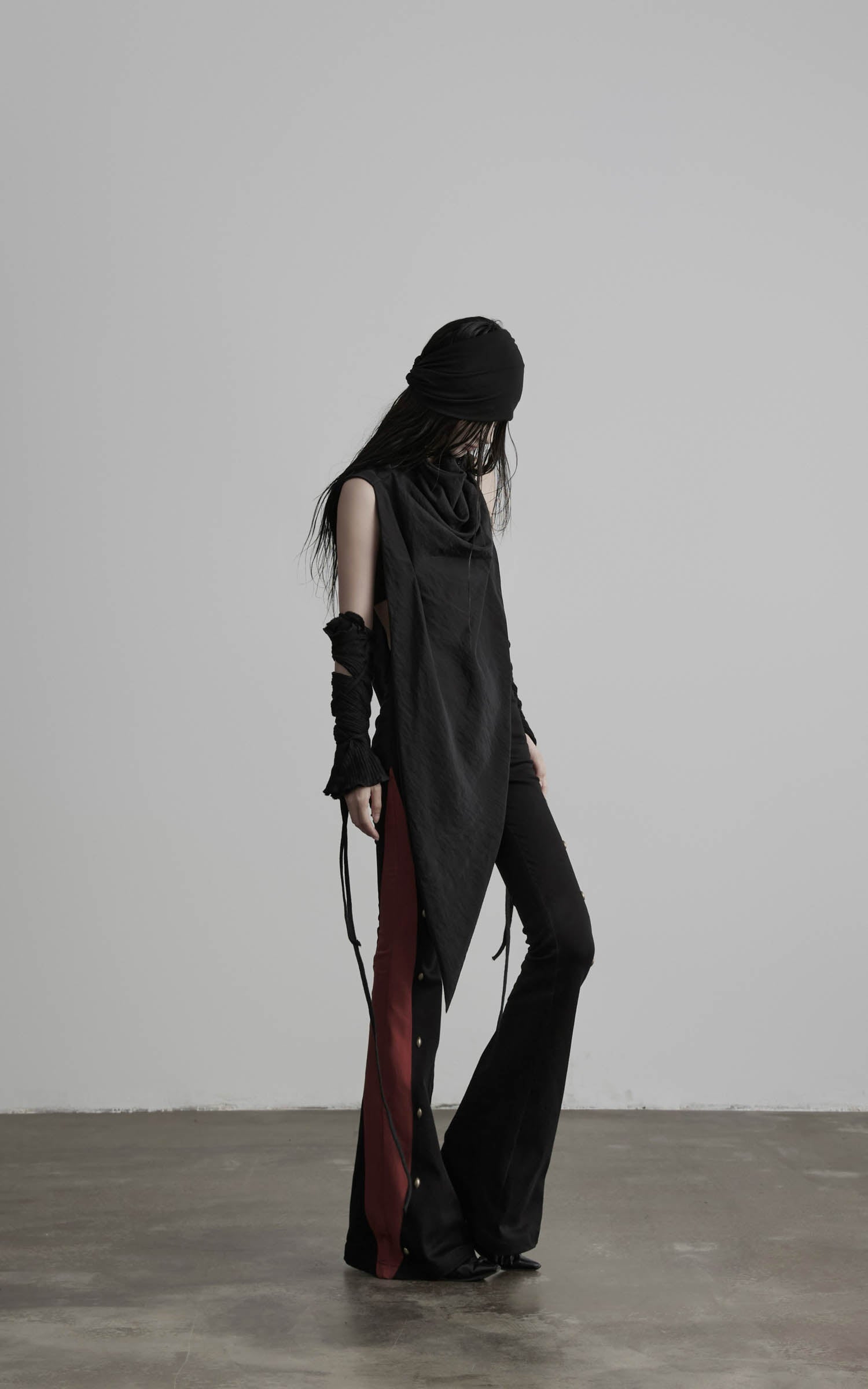 side view of black contrast panel flared pants in full length