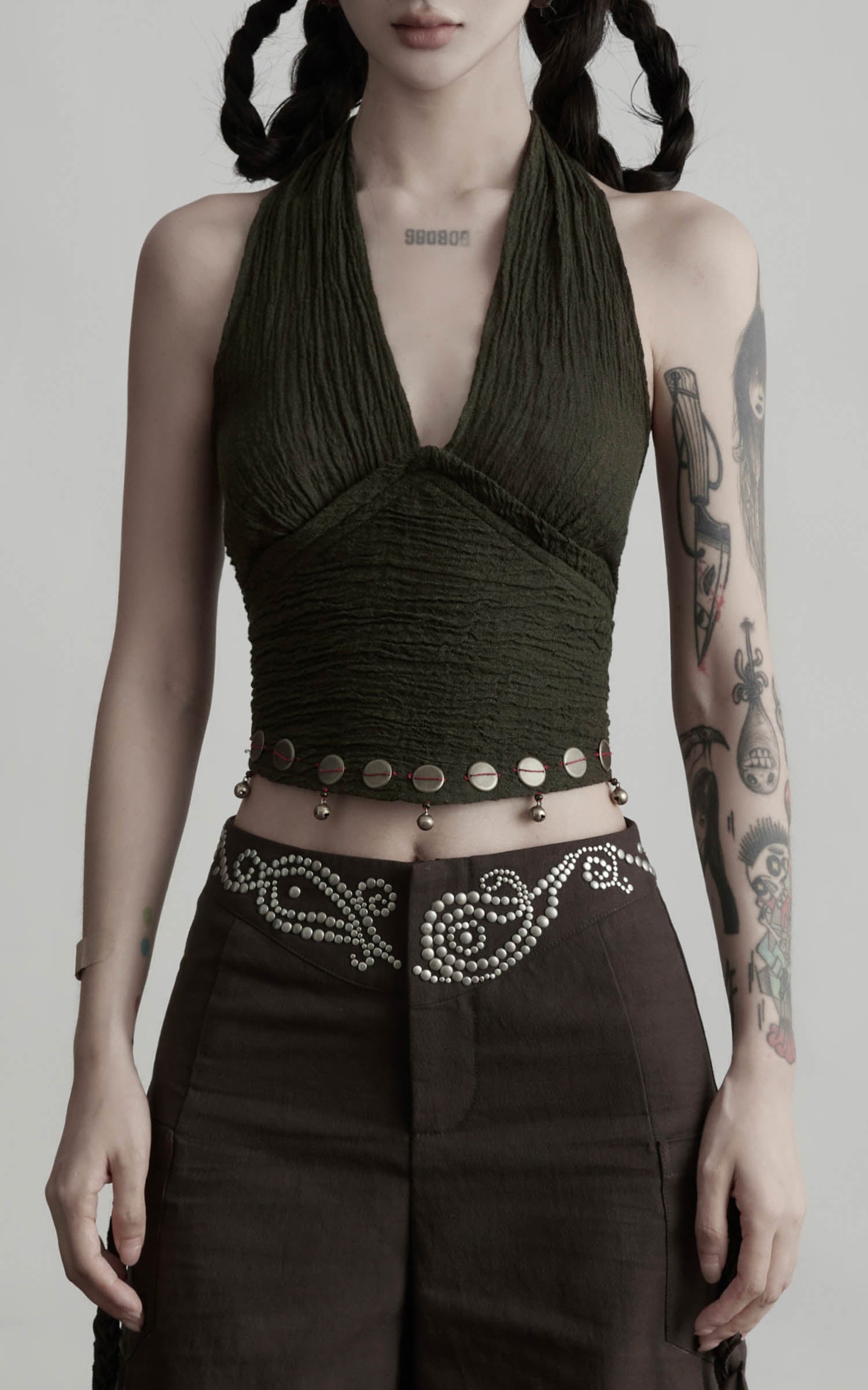 Close-up of dark olive halter tie-up crop top with ruched texture