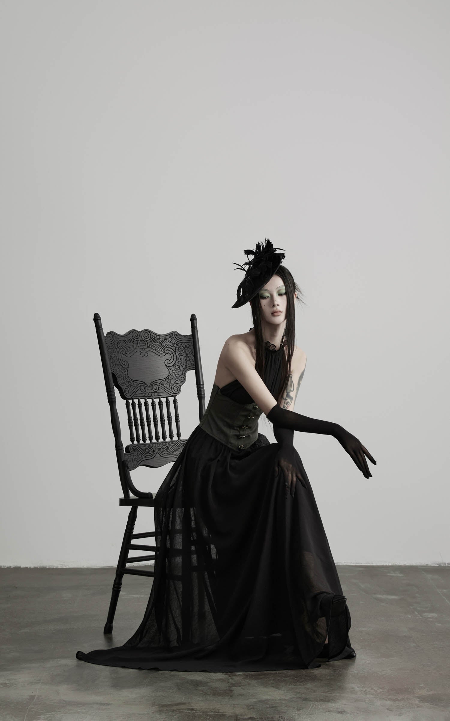 Black gathered halter corset maxi dress with structured waist panel angled view