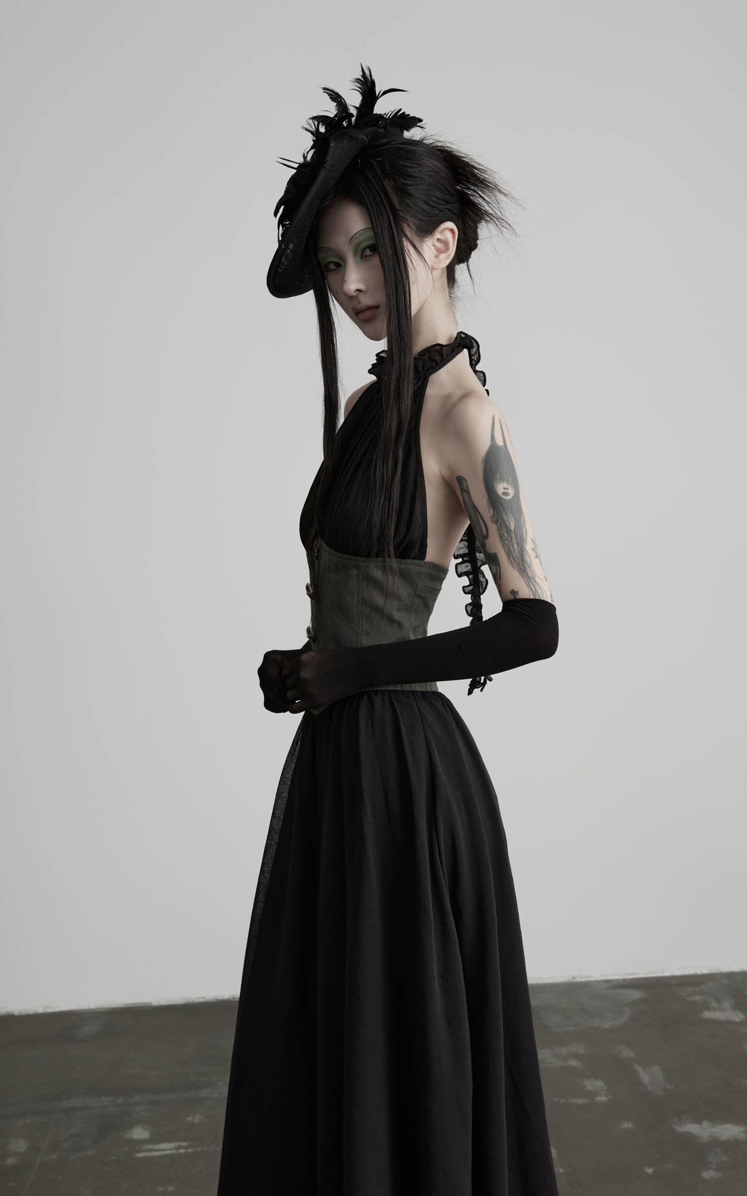 Black gathered halter corset maxi dress with buttoned waist panel angled view