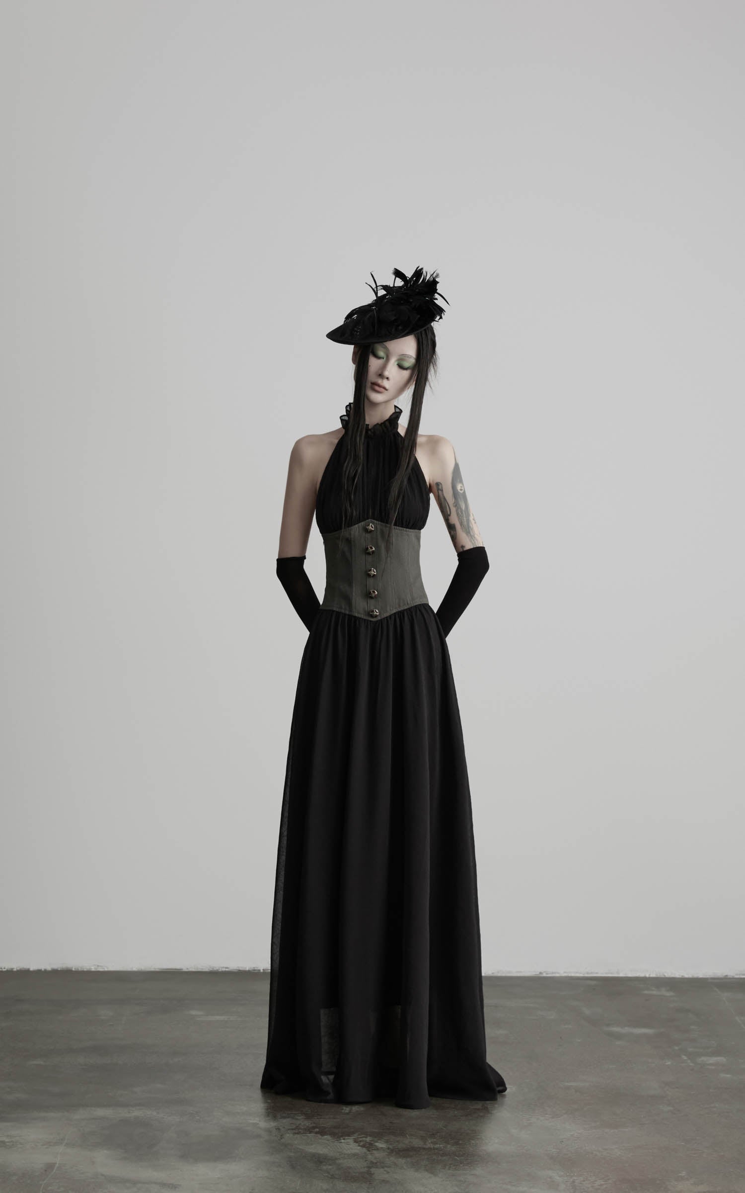 Black gathered halter corset maxi dress with elongated skirt line front view