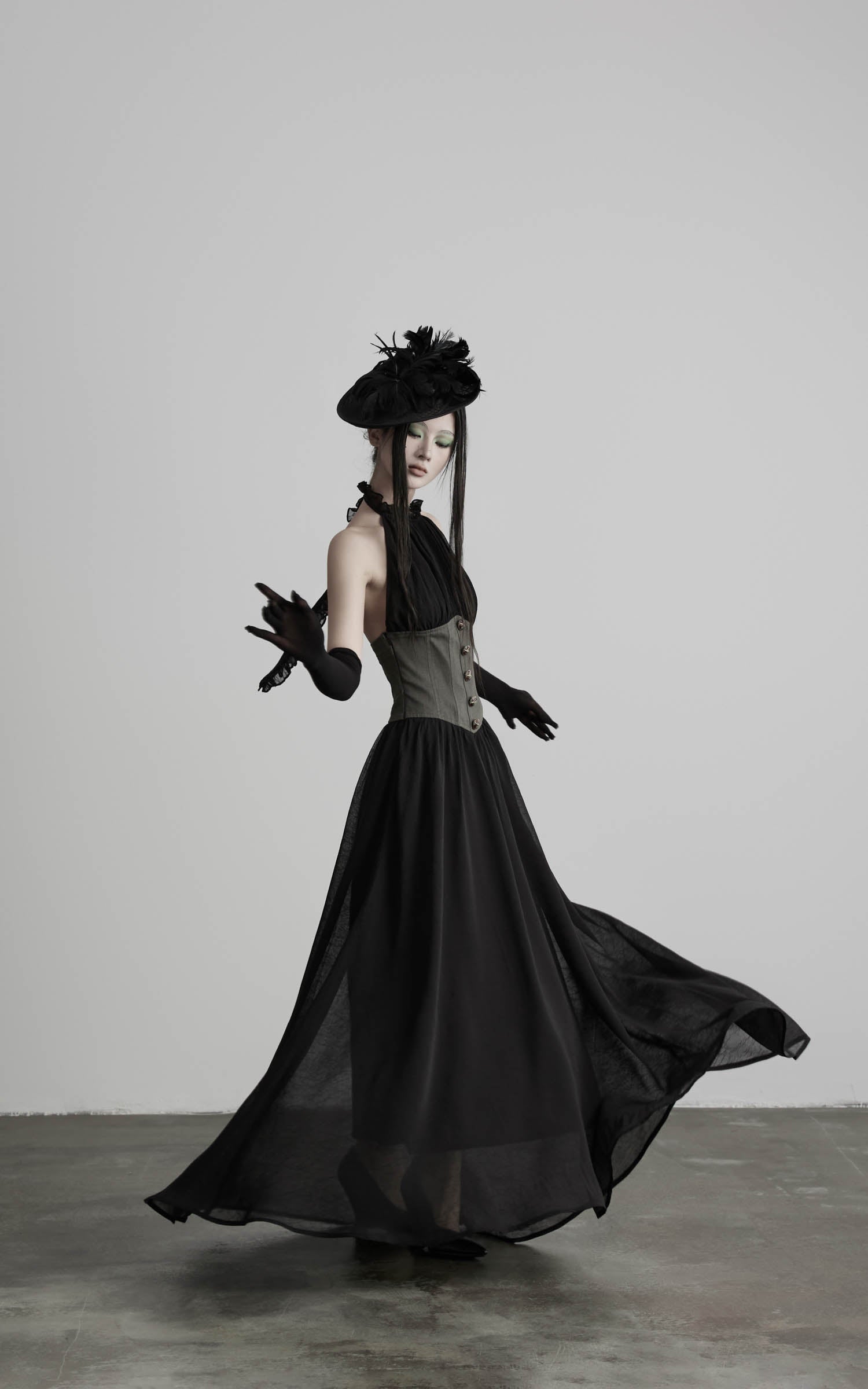 Black gathered halter corset maxi dress with flowing sheer hem side view