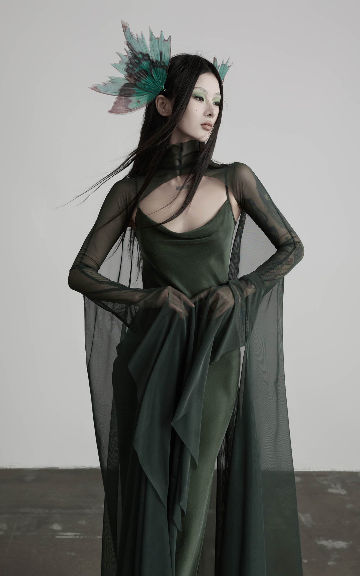 Dark green slip maxi dress with mesh cape angled front detail