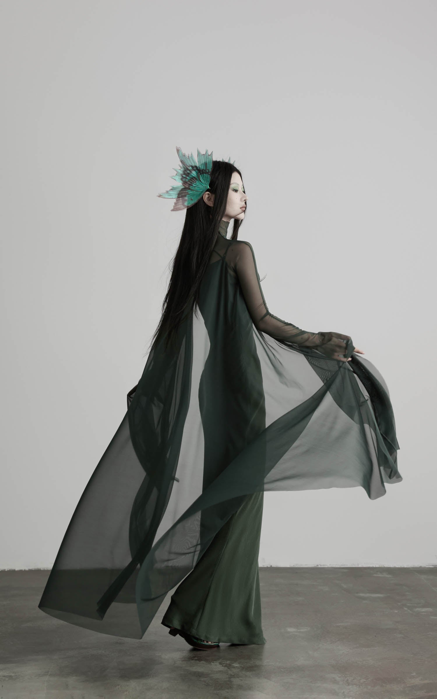 Dark green slip maxi dress with flowing mesh cape side back view
