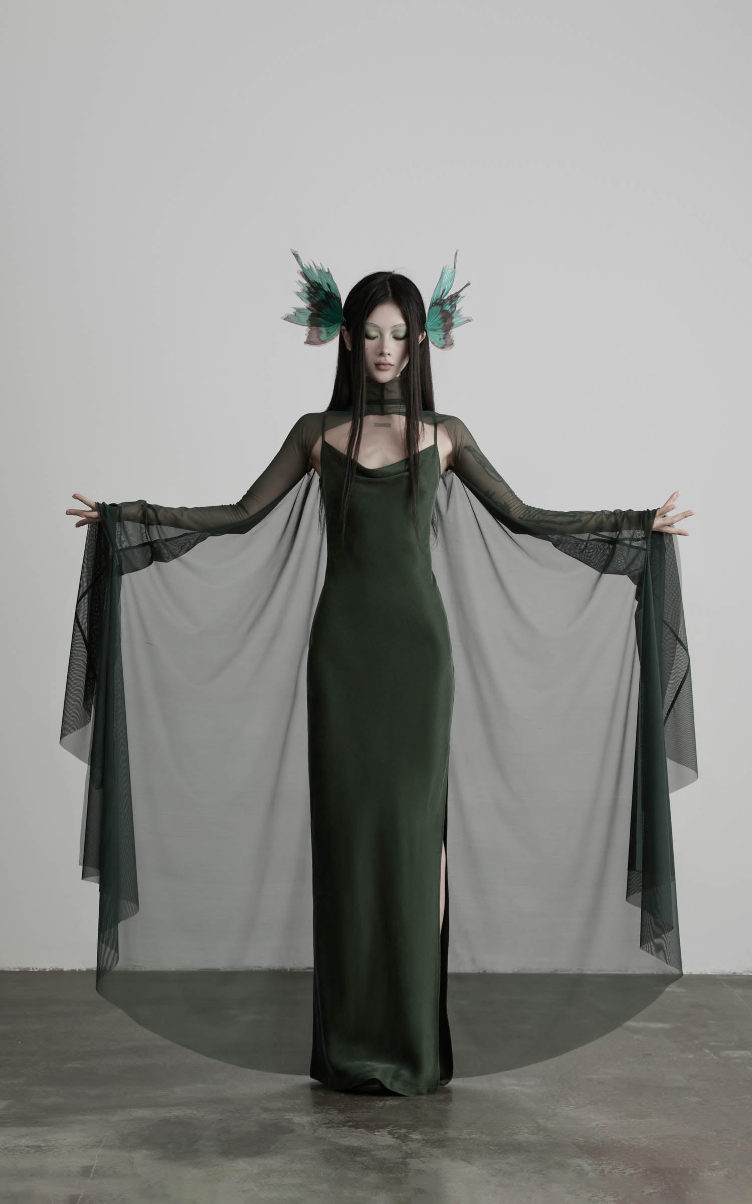 Dark green slip maxi dress with flowing mesh cape front view