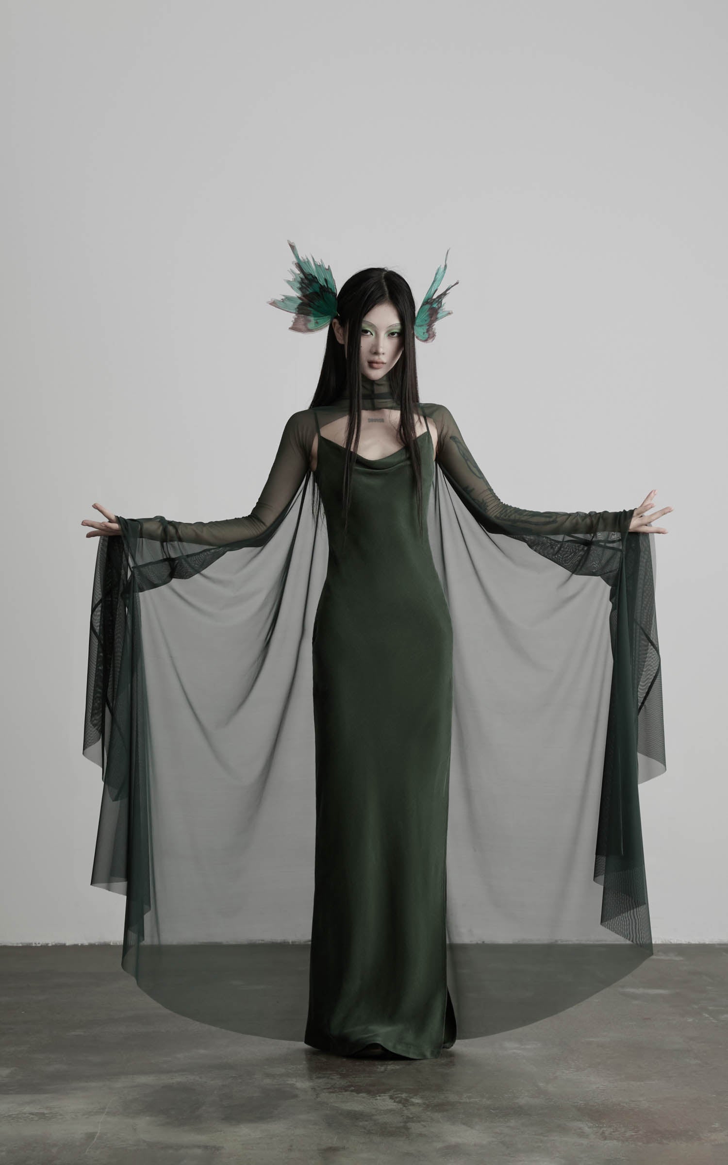 Dark green slip maxi dress with wide mesh cape front view
