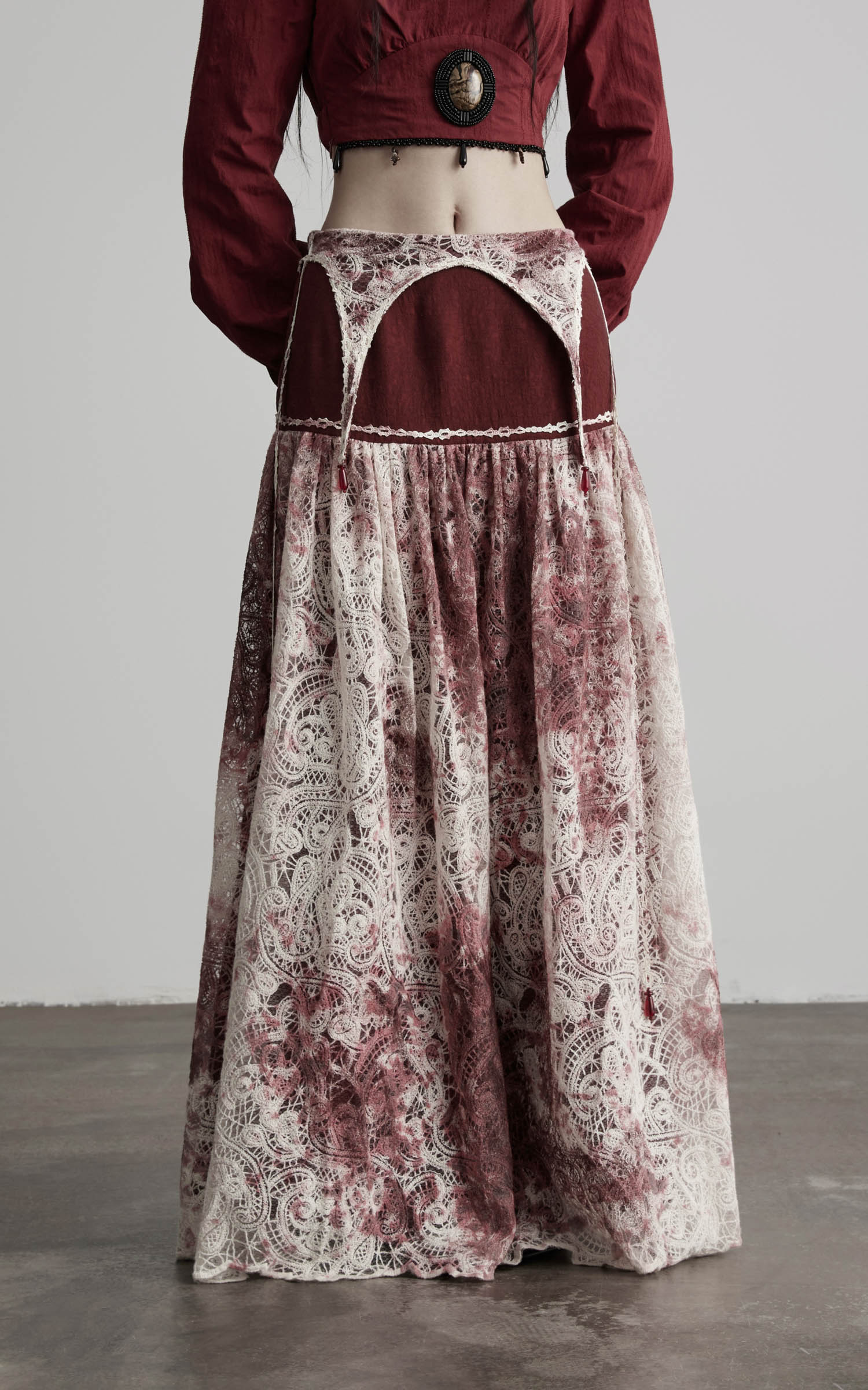 front view of low rise maxi skirt in burgundy and ivory with layered waist
