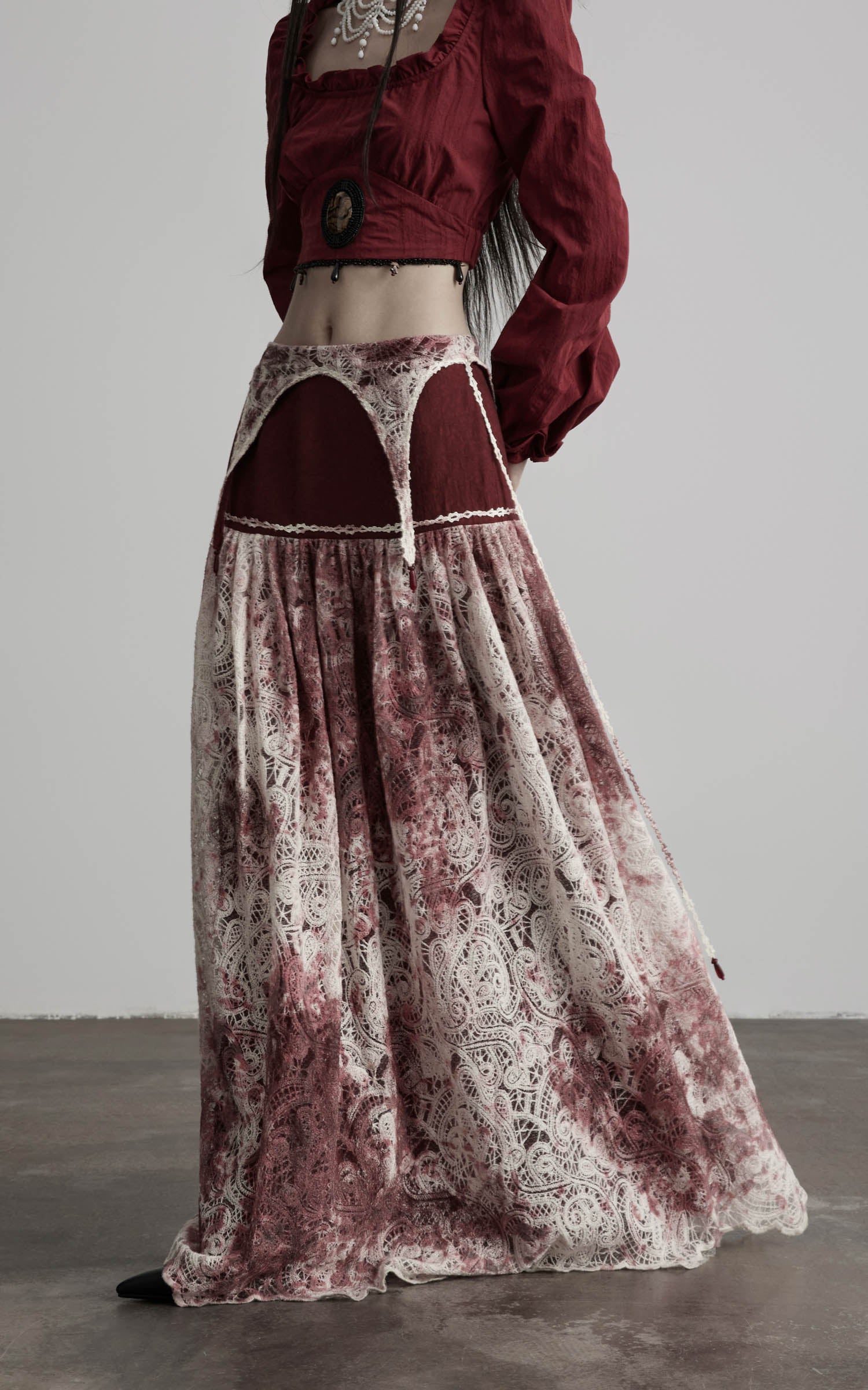side view of low rise maxi skirt in burgundy and ivory with flowing hem