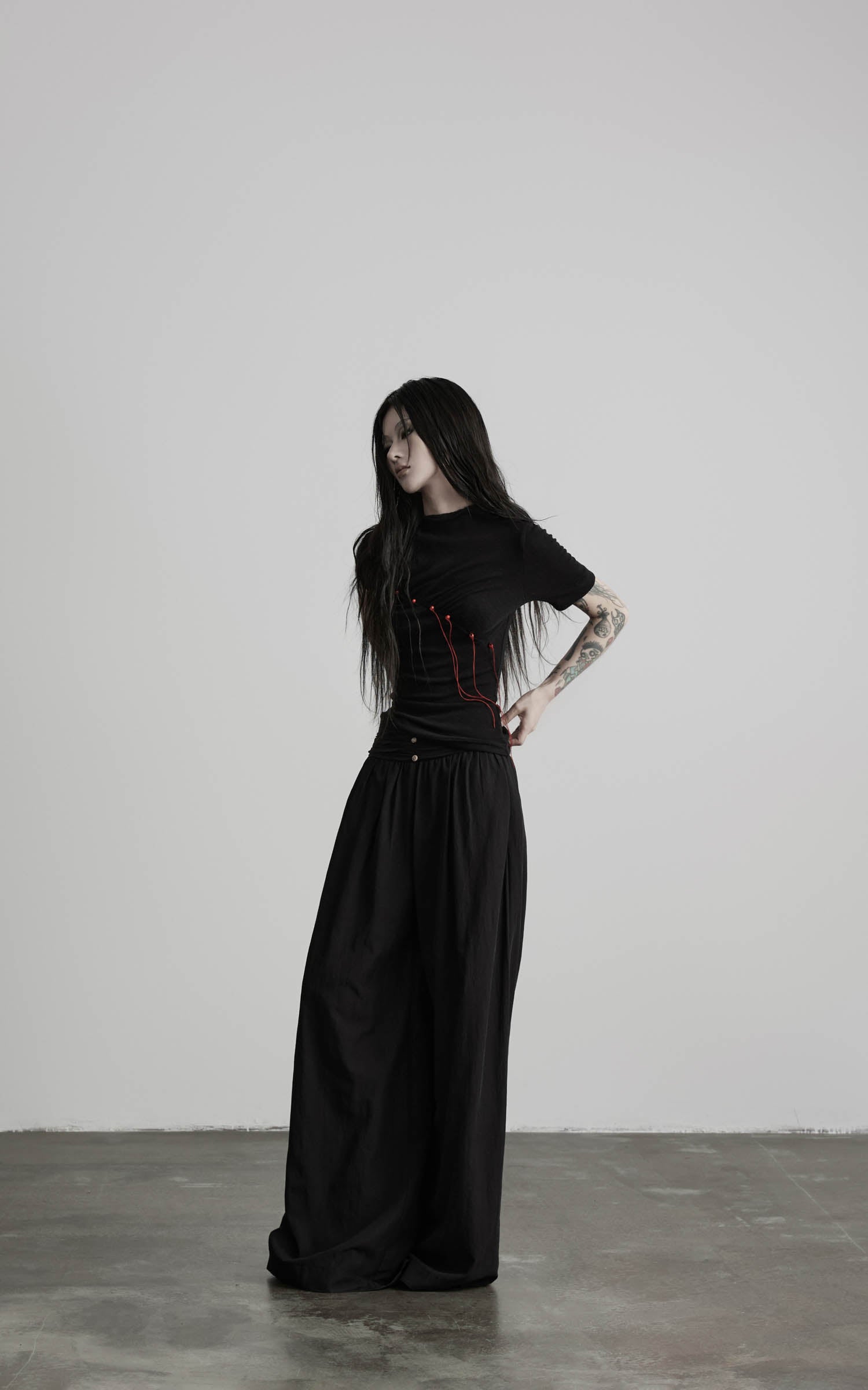 Black mock neck ruched knit T-shirt with asymmetric ruching angled view