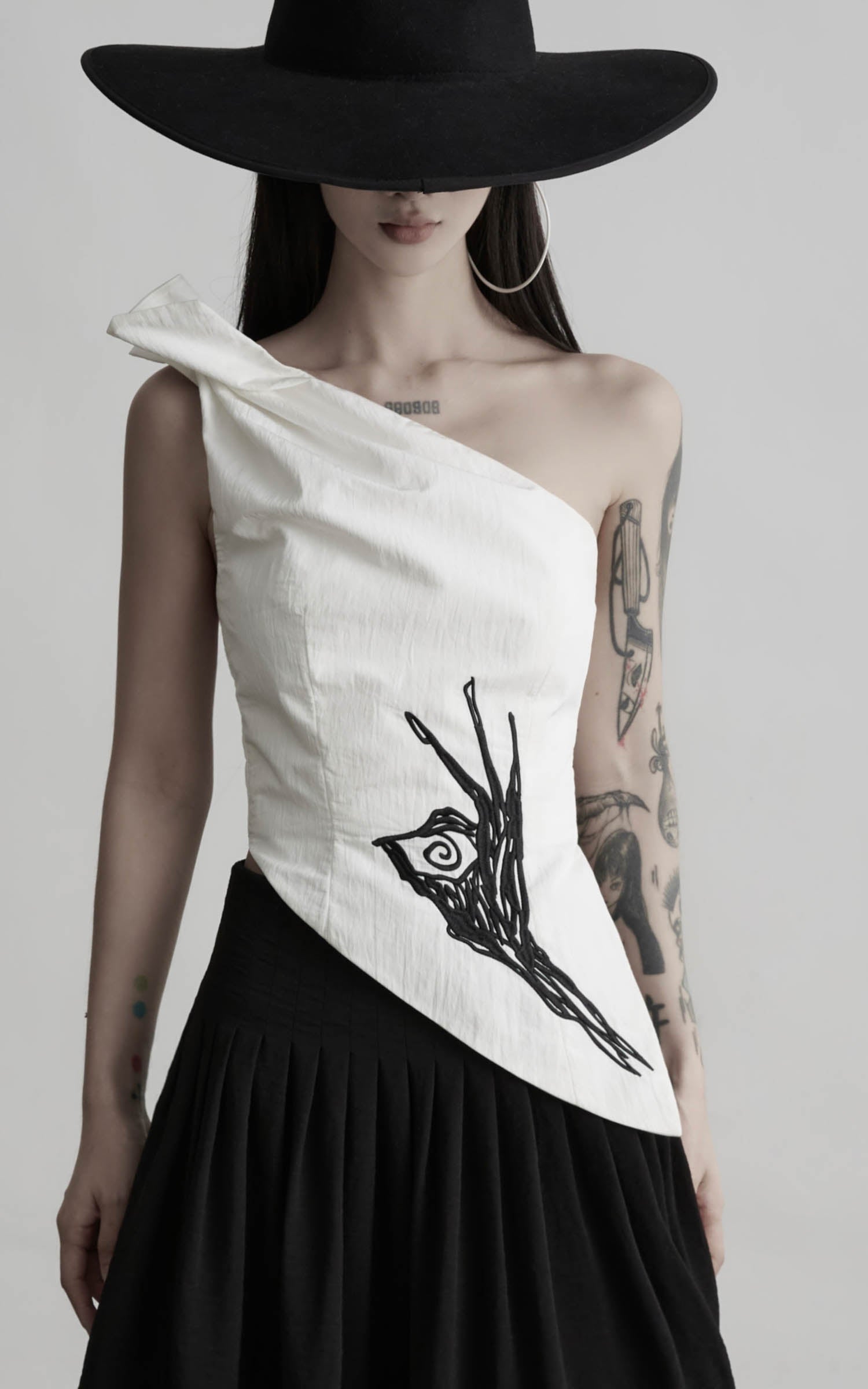 Load video: DOINDULGE One Shoulder Asymmetric Embroidered Top