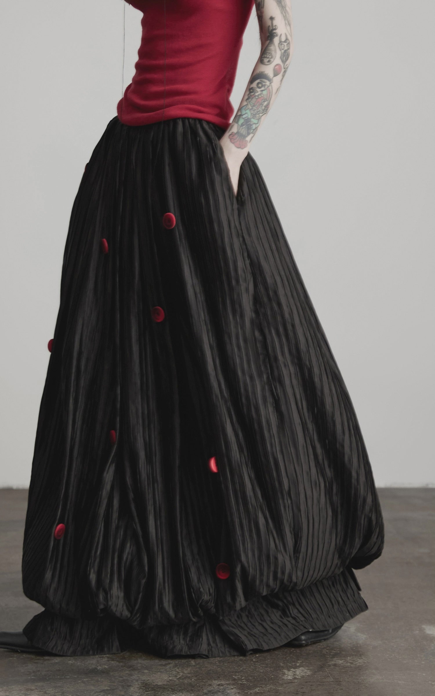 Load video: INDULGE Black Pleated Skirt Red Button Accents