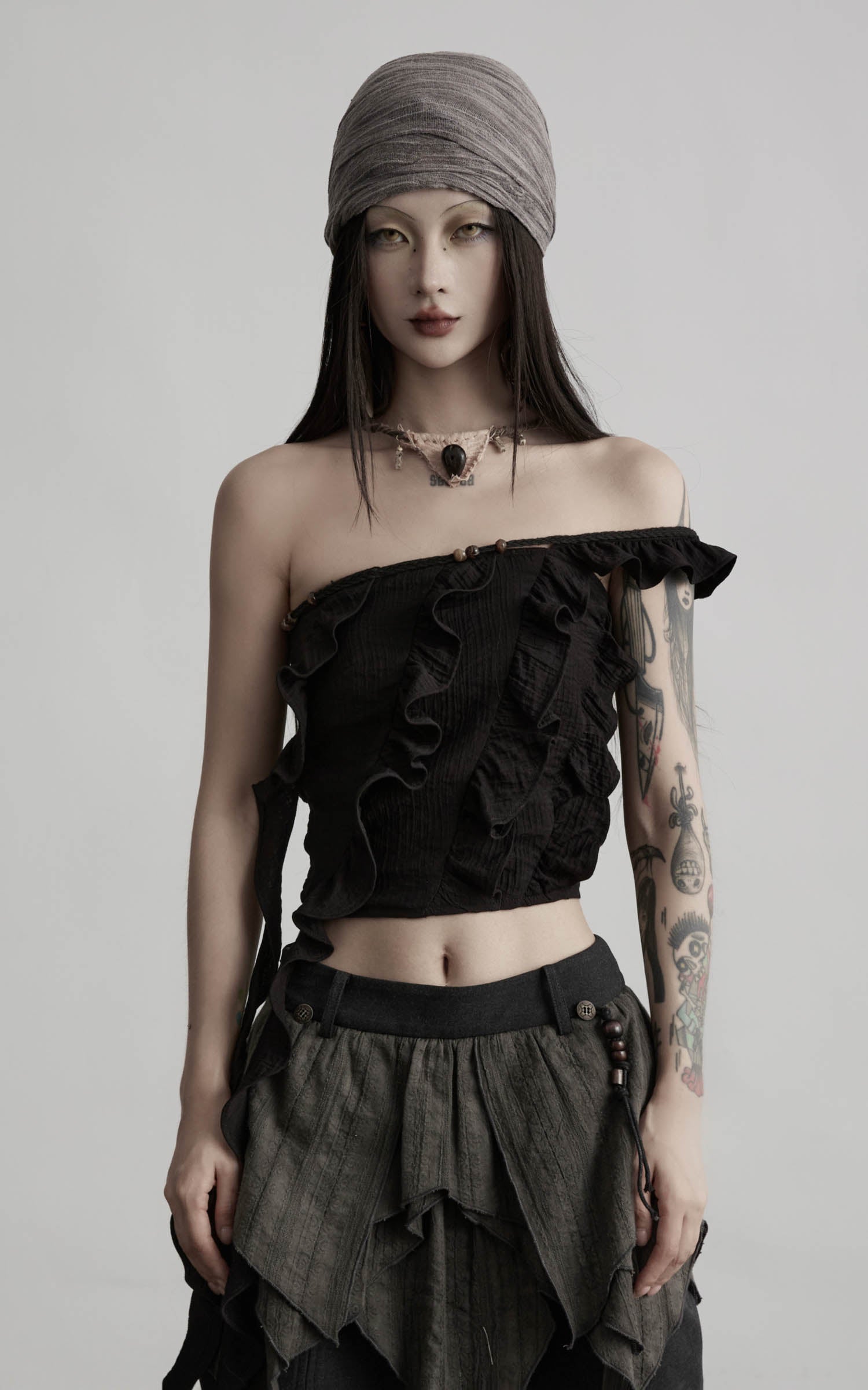 front view of black ruffled off shoulder crop top with soft gathered texture