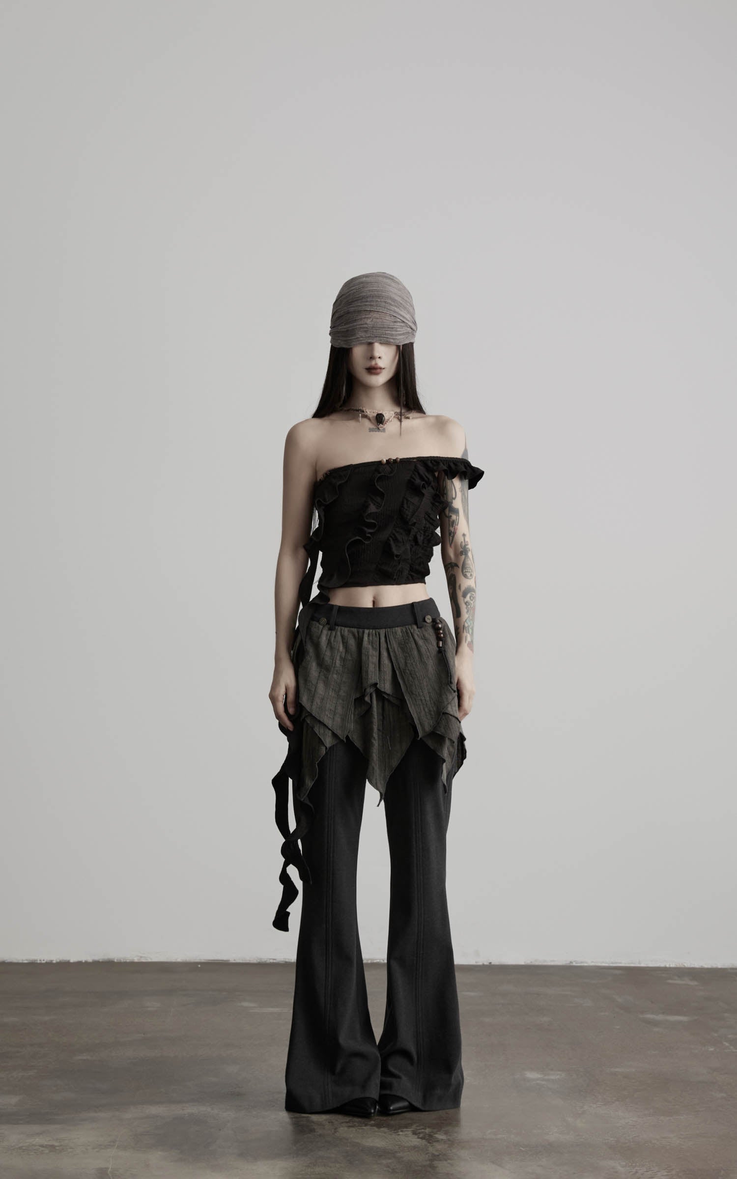front view of black ruffled off shoulder crop top with structured neckline