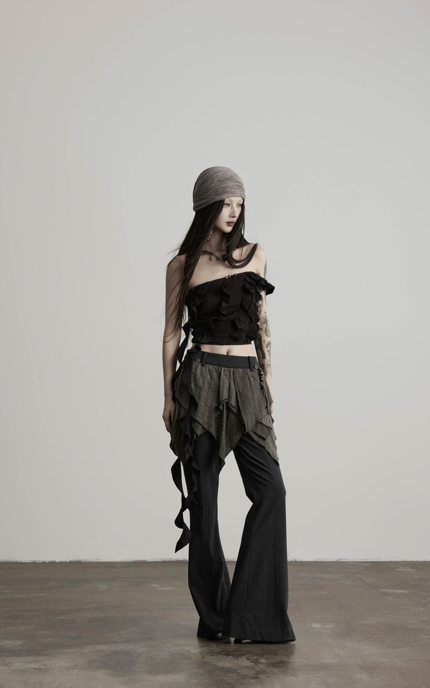 front view of black ruffled off shoulder crop top with cropped silhouette
