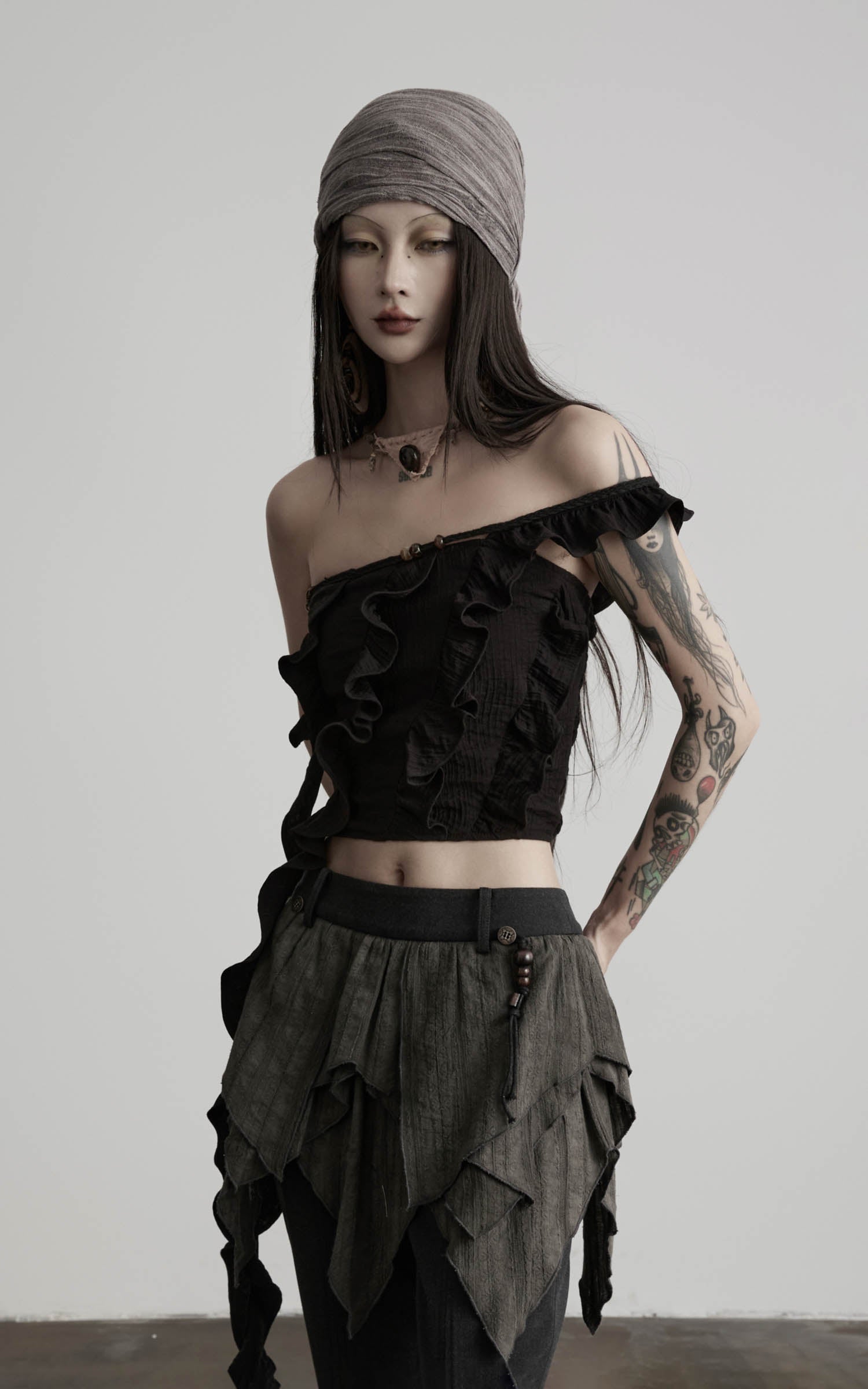 side view of black ruffled off shoulder crop top with layered ruffle edges