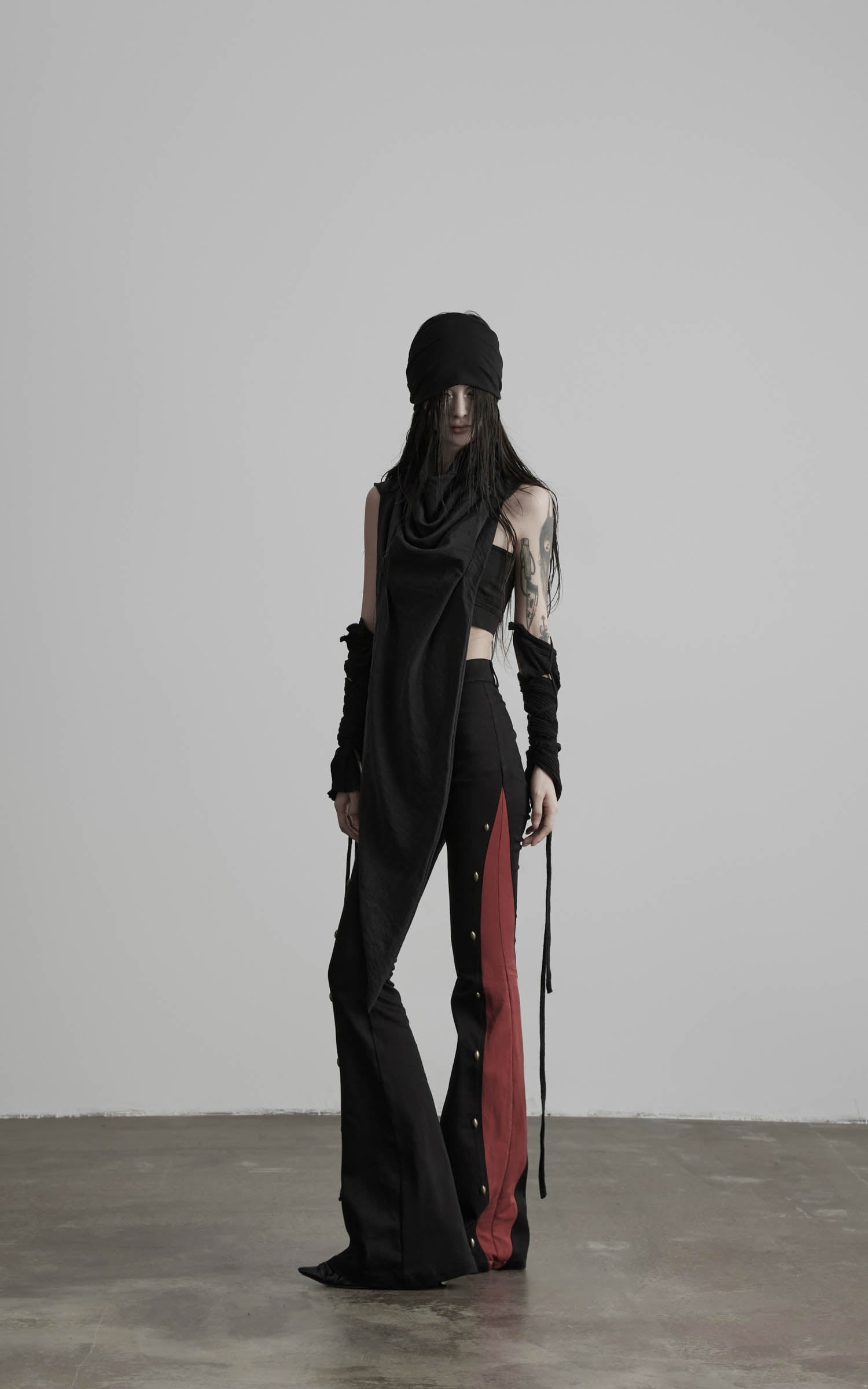 front view of black low-rise flared pants with contrast panel design