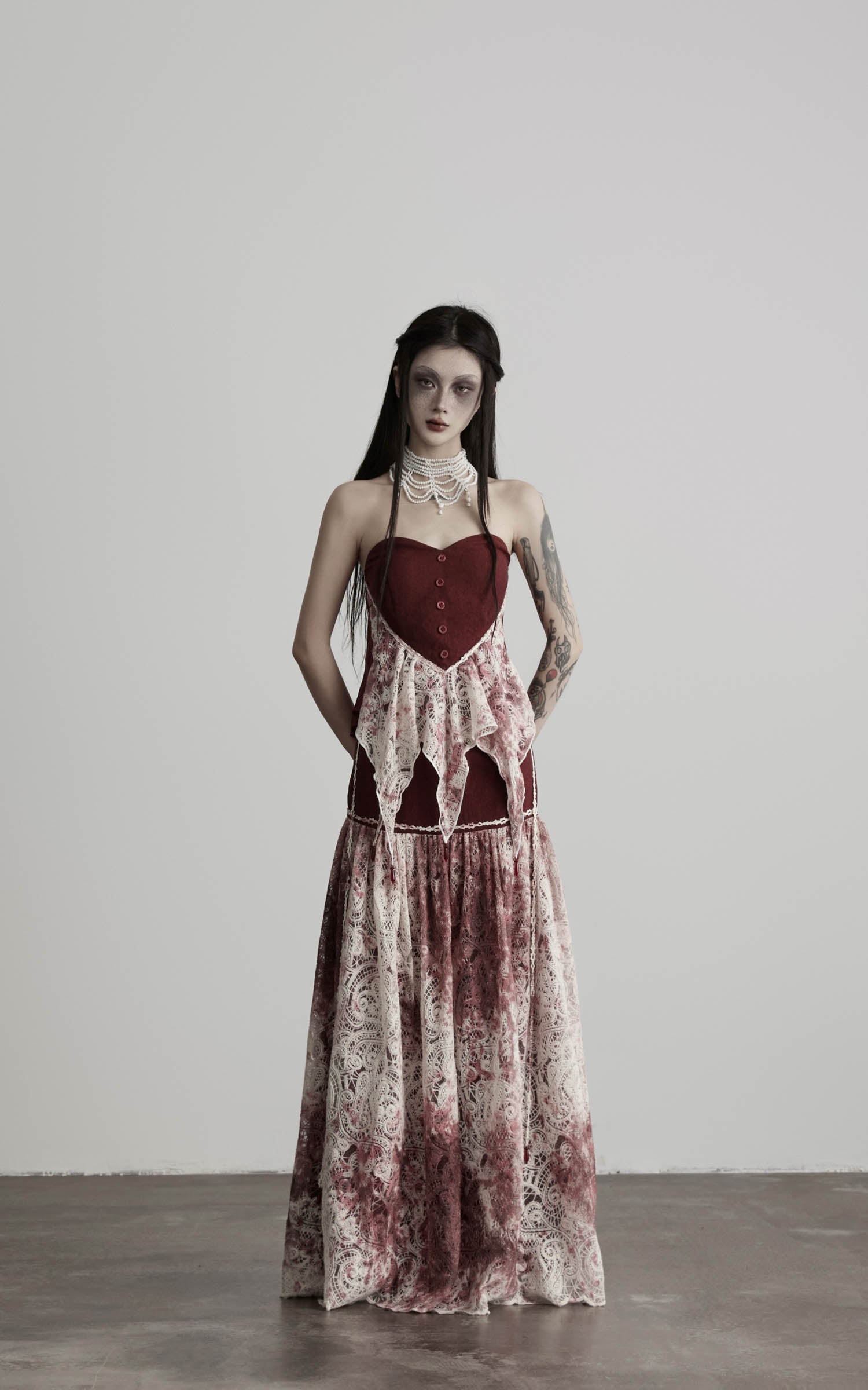 front view of red strapless top with lace overlay and soft drape