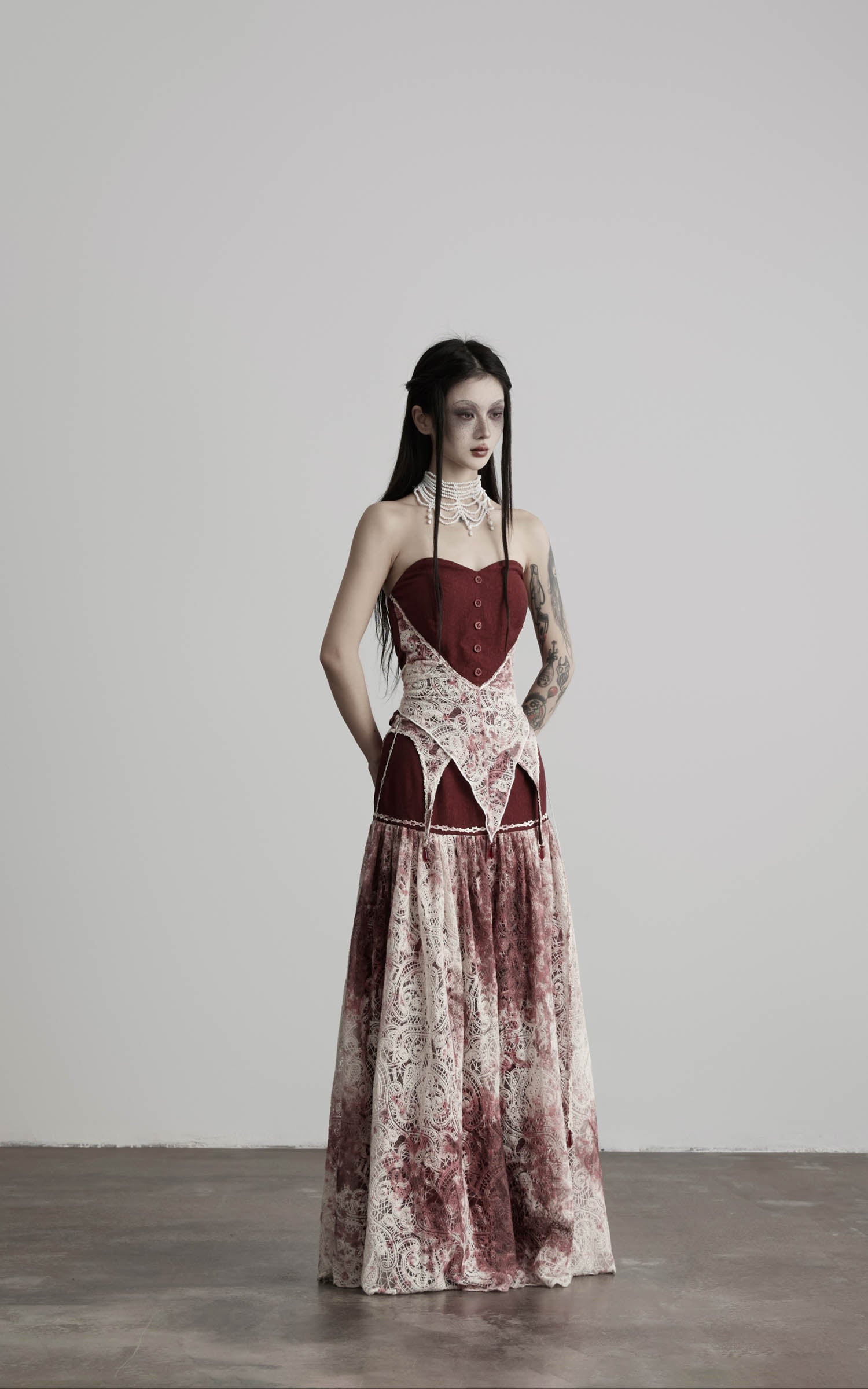 front view of red strapless top with lace panel and flowing skirt