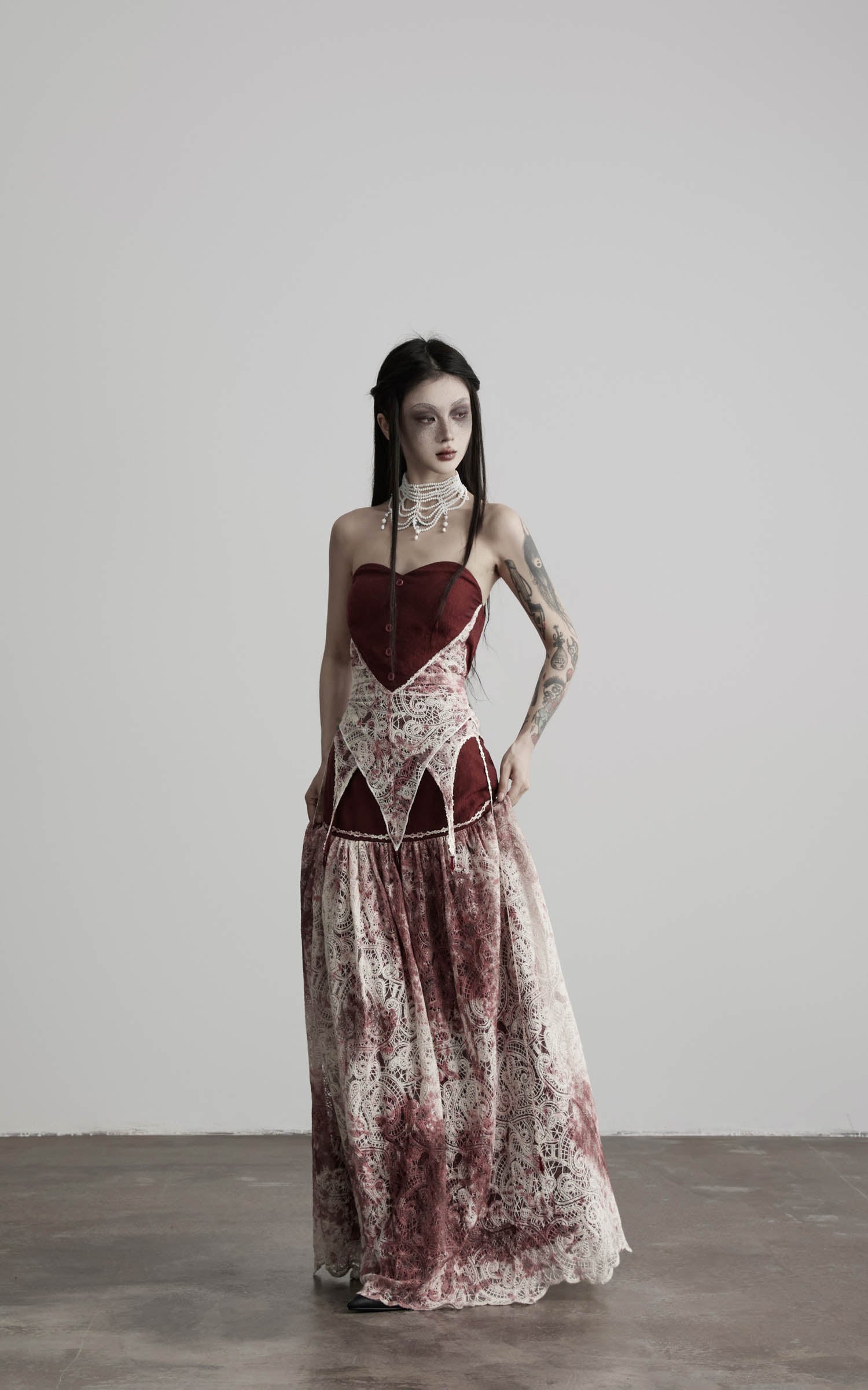 front view of red strapless top with lace panel and long skirt