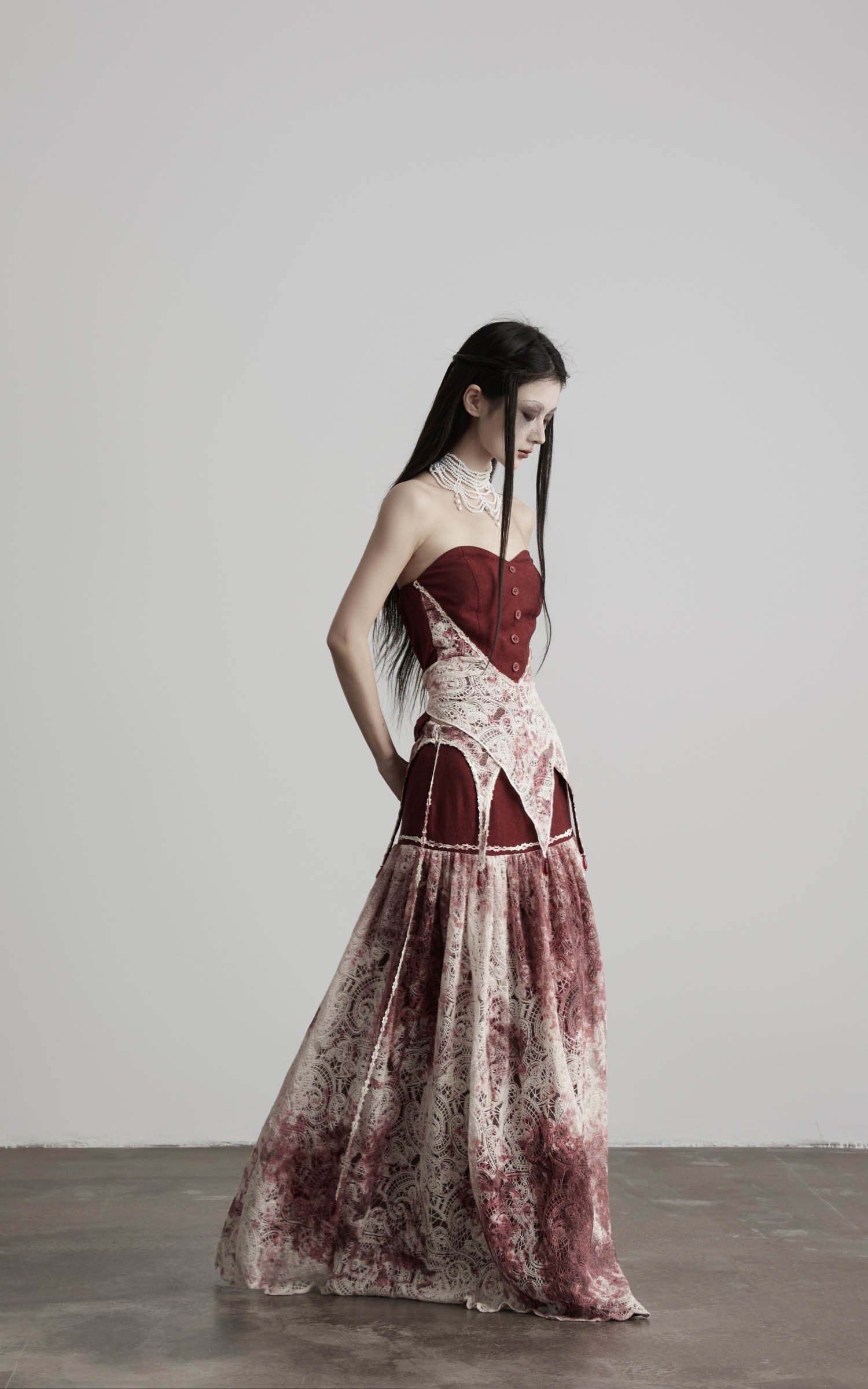 side view of red strapless top with lace panel and long silhouette