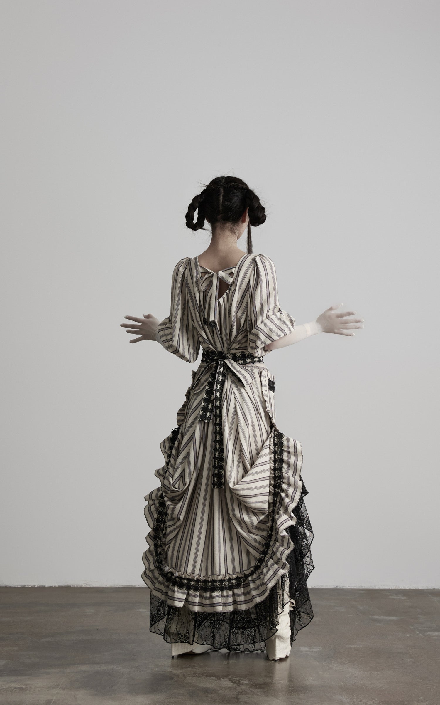 back view of beige striped maxi dress with tie back detail