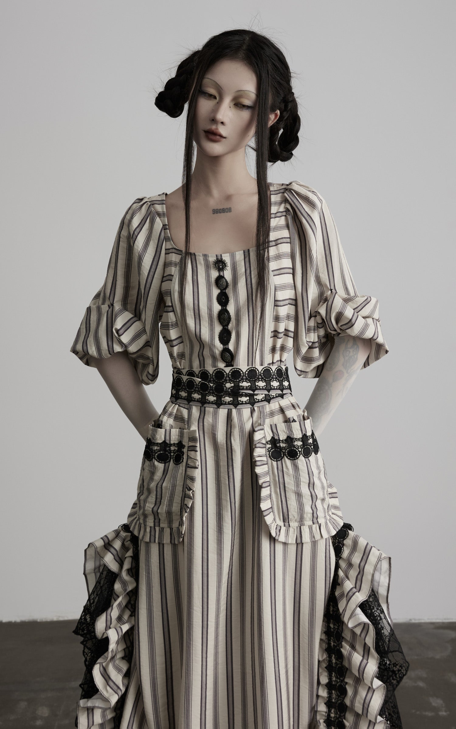 close-up of beige striped maxi dress with neckline and buttons