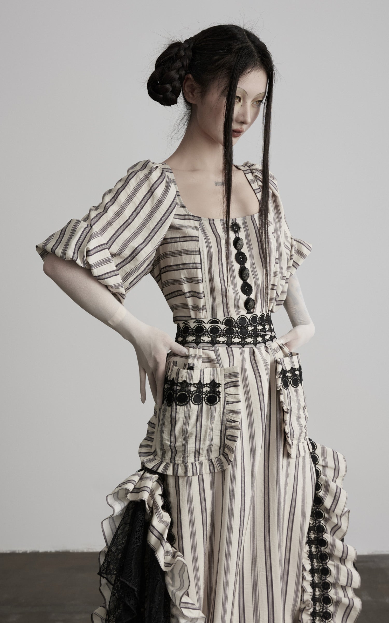 close-up of beige striped maxi dress with waist and pocket detail