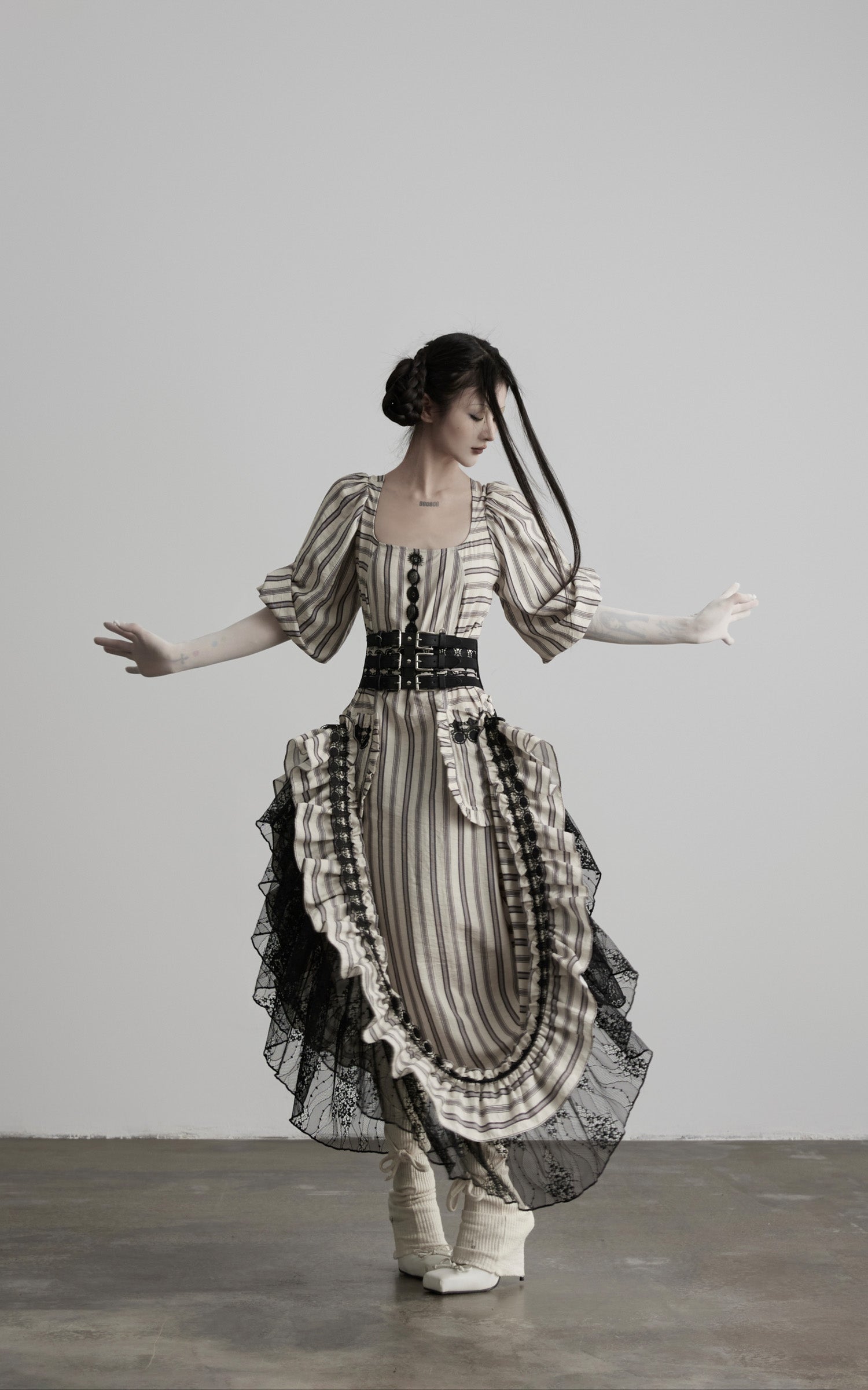 front view of beige striped maxi dress with black lace trim
